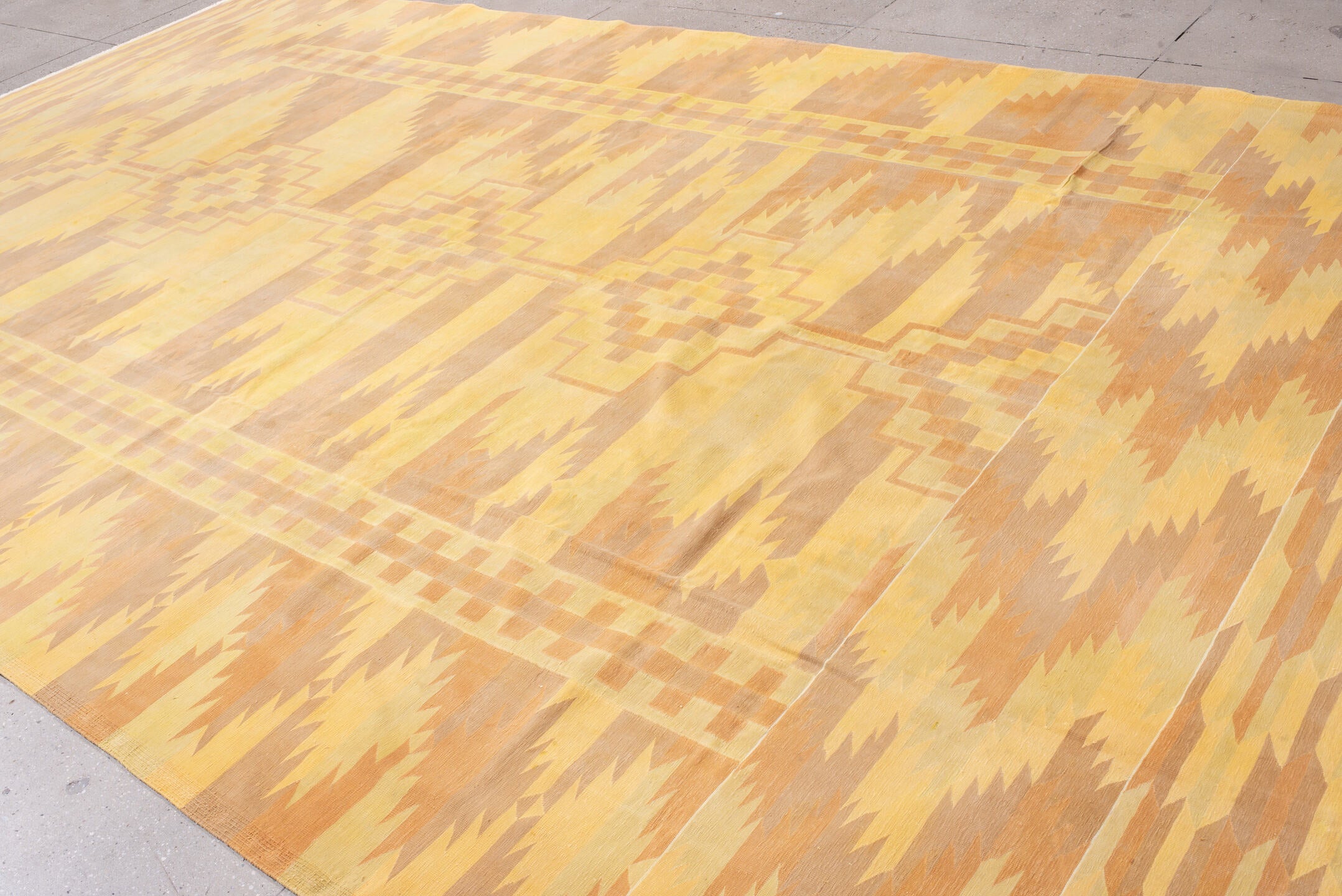 9' x 16' one-of-a-kind handmade vintage Dhurrie rug. Color palette: brown, yellow, orange, off-white, pink, navajo white