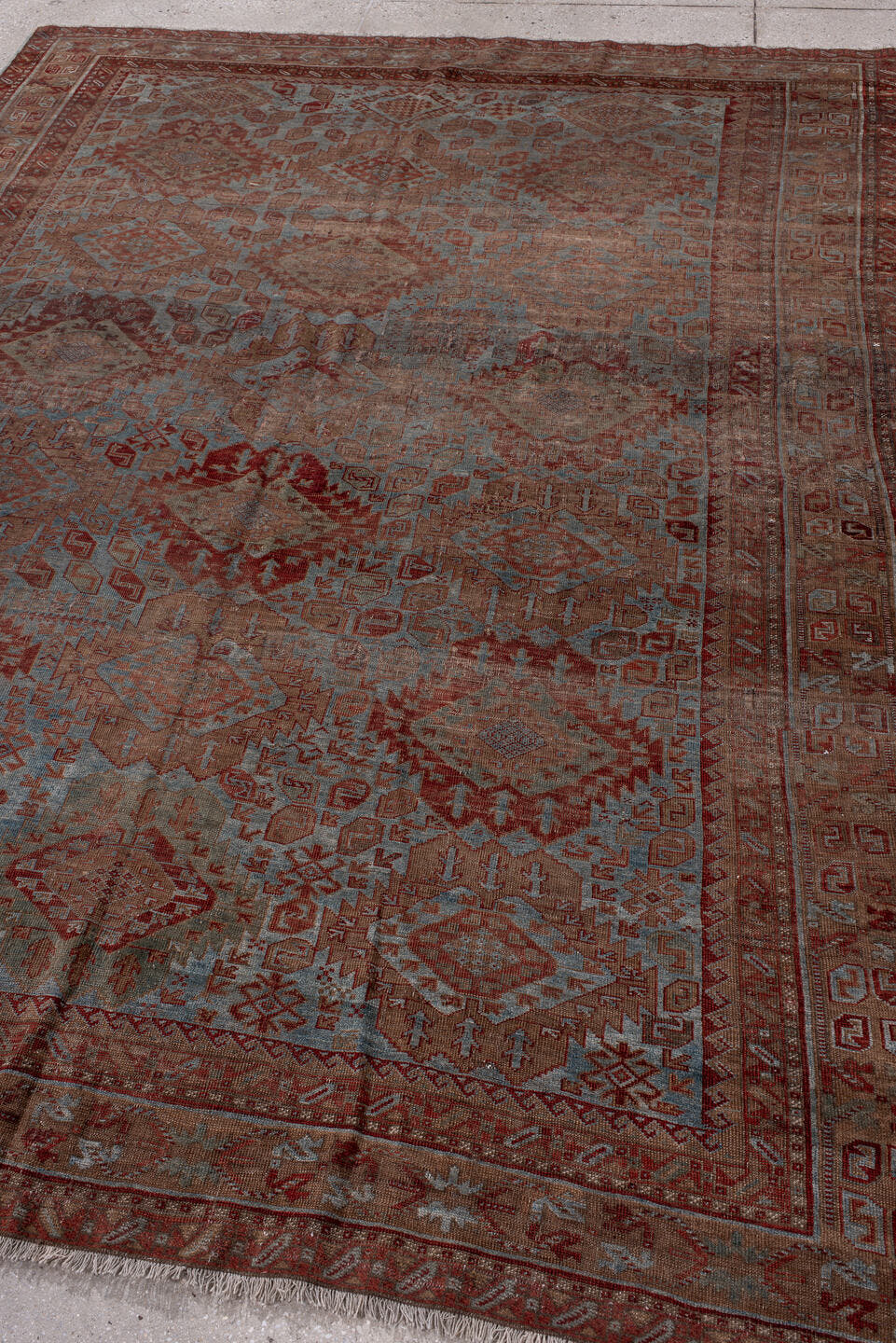 6' x 9' one-of-a-kind handmade antique Belouch rug. Color palette: rust, dusty blue, ivory, taupe, burgundy, brown