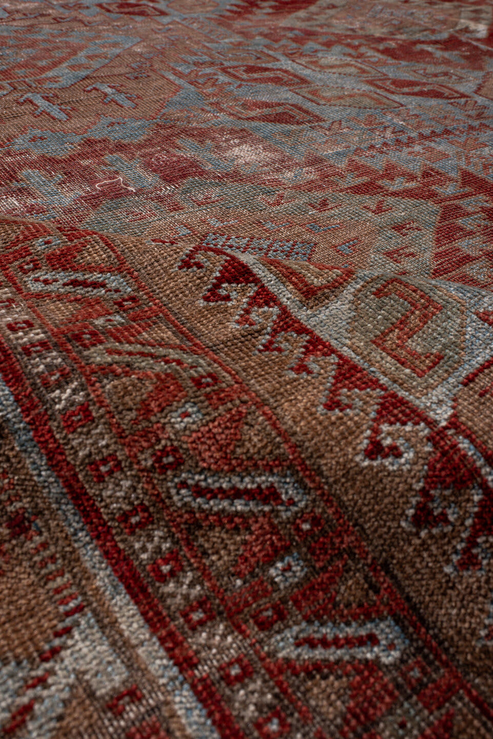 6' x 9' one-of-a-kind handmade antique Belouch rug. Color palette: rust, dusty blue, ivory, taupe, burgundy, brown