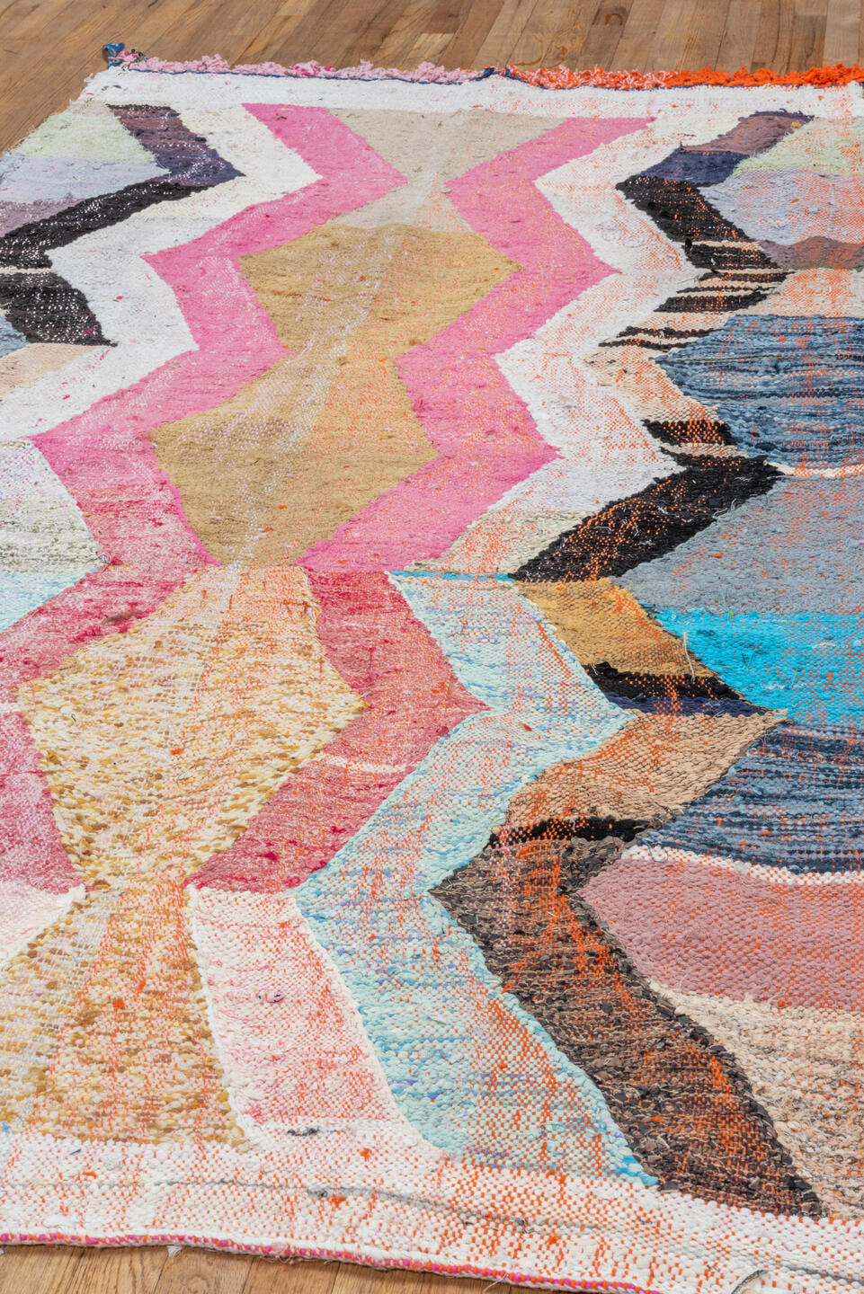 4' x 8' one-of-a-kind handmade vintage Rag Rug rug. Color palette: ivory, pink, tan, charcoal, sky_blue, taupe, orange