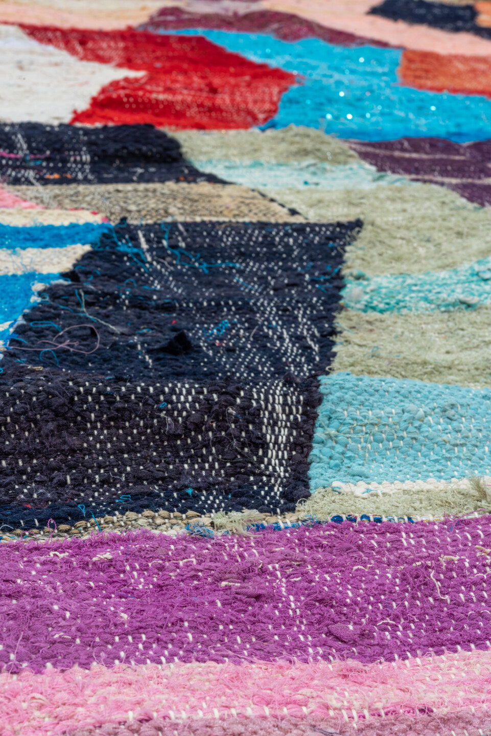 4' x 8' one-of-a-kind handmade vintage Rag Rug rug. Color palette: blue, brown, gray, light gray, off-white, pink, red