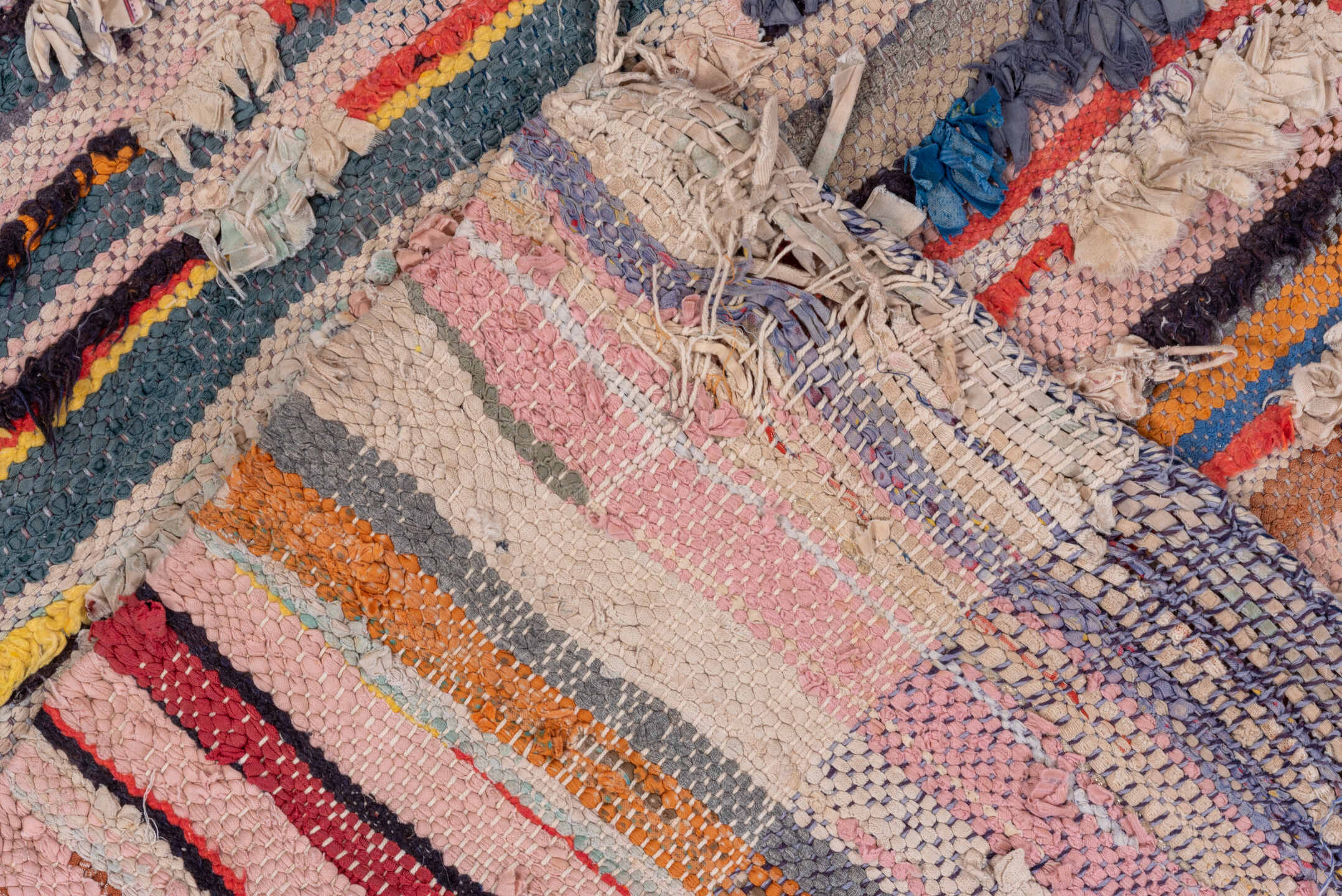 4' x 7' one-of-a-kind handmade vintage Rag Rug rug. Color palette: blue, brown, dark gray, gray, light gray, off-white, pink