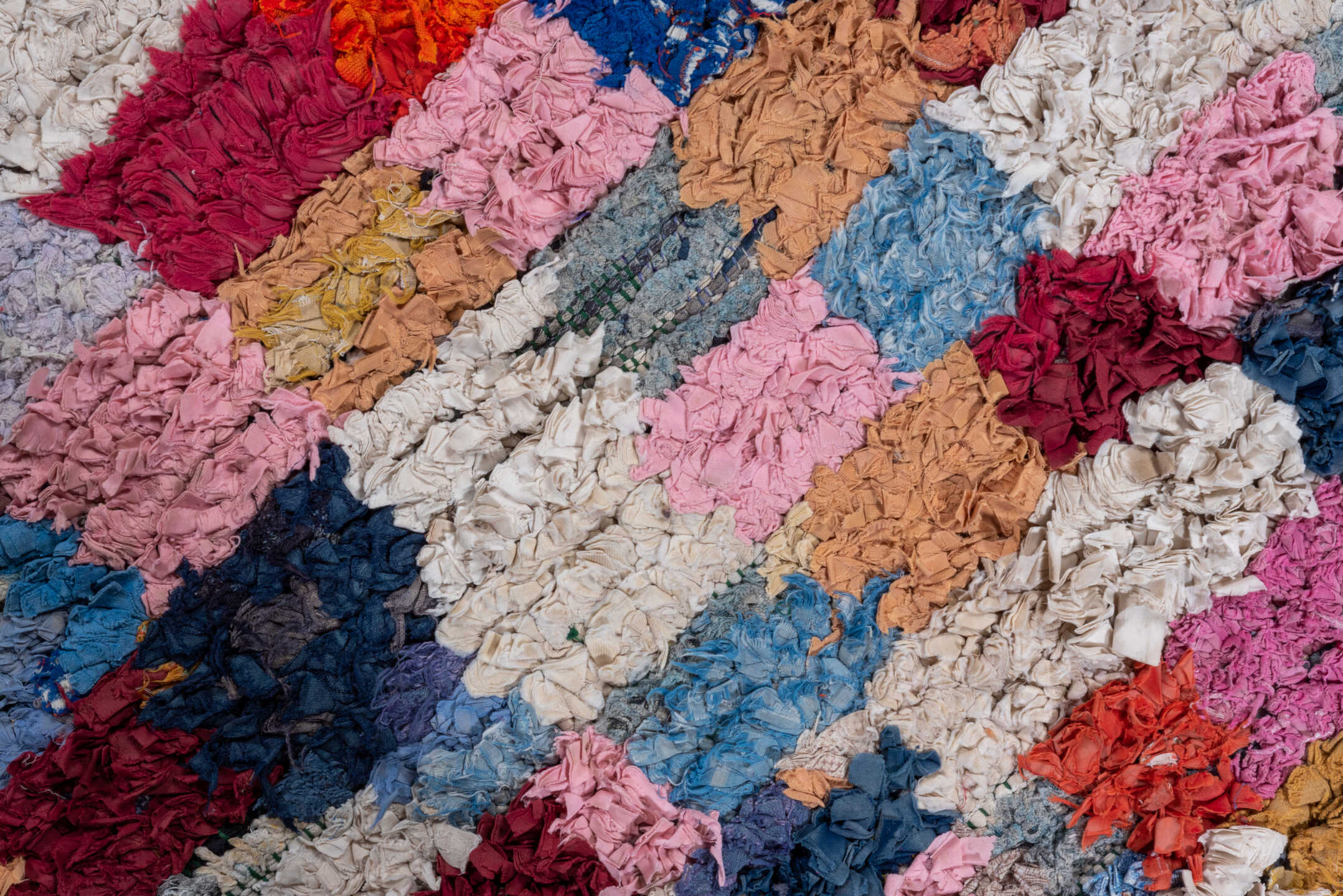 3' x 7' one-of-a-kind handmade vintage Rag Rug runner rug. Color palette: ivory, blush, denim, crimson, lavender, sky_blue