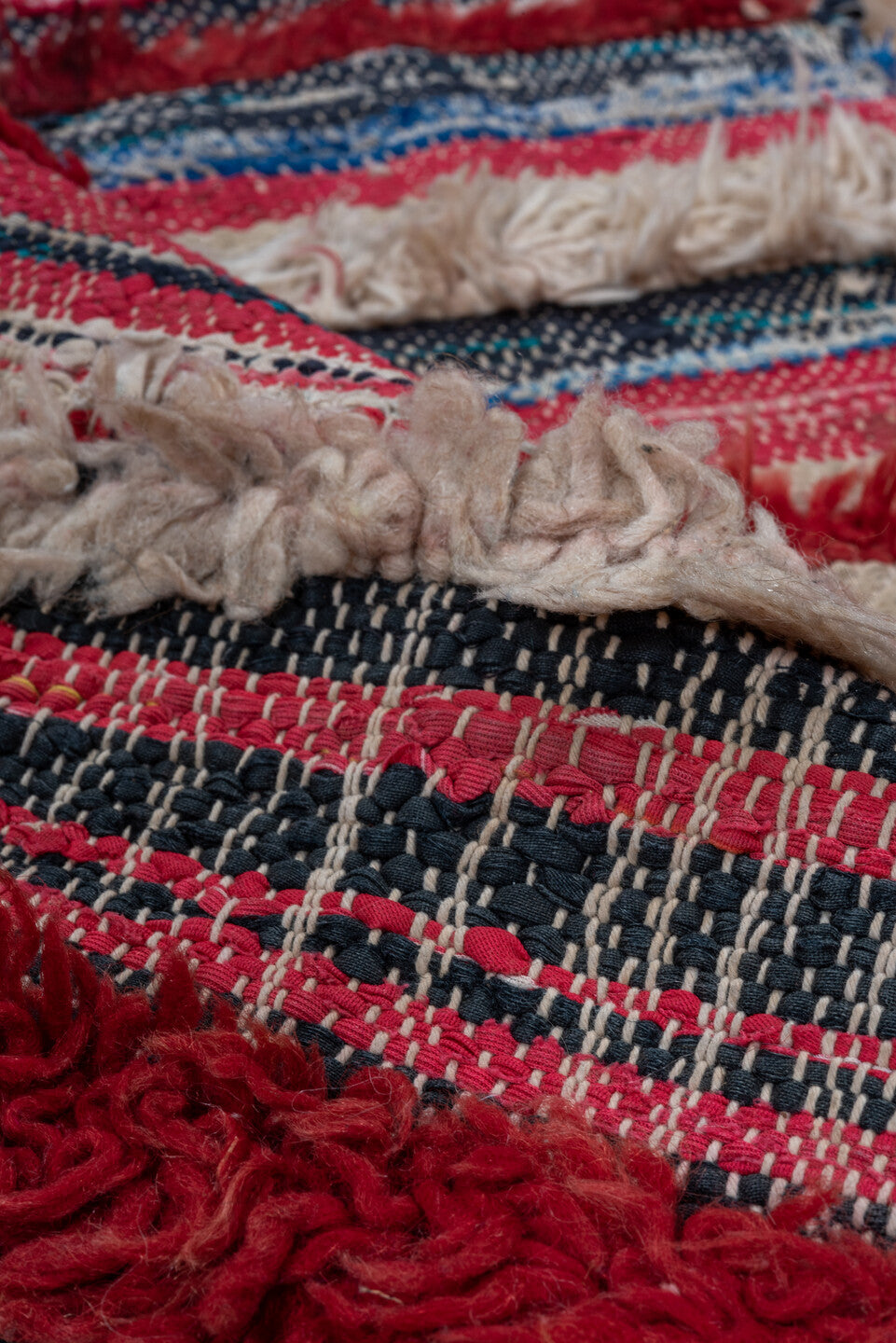 2' x 6' one-of-a-kind handmade vintage Rag Rug runner rug. Color palette: black, blue, brown, gray, light gray, off-white