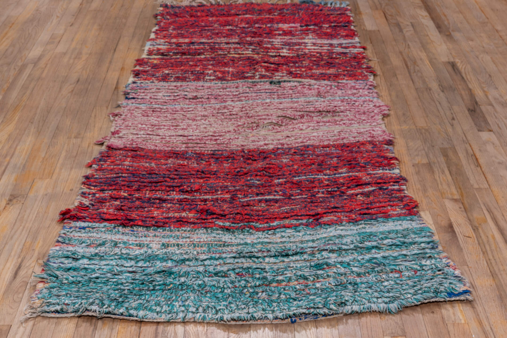 3' x 8' one-of-a-kind handmade vintage Rag Rug runner rug. Color palette: crimson, ivory, red, aqua, navy, rose, teal, blue