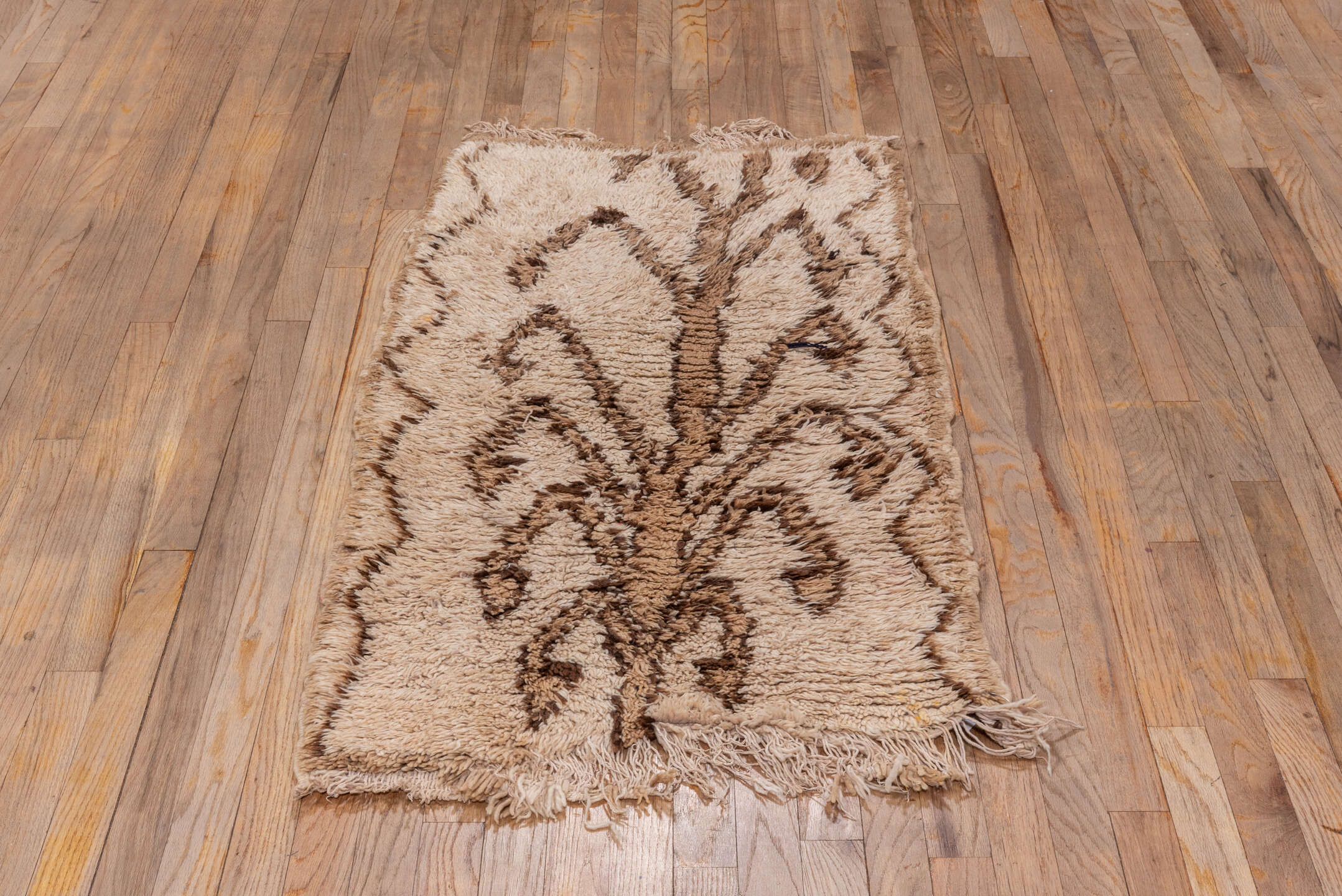 2' x 4' one-of-a-kind handmade vintage Moroccan small size rug. Color palette: brown, gray, light gray, off-white, orange