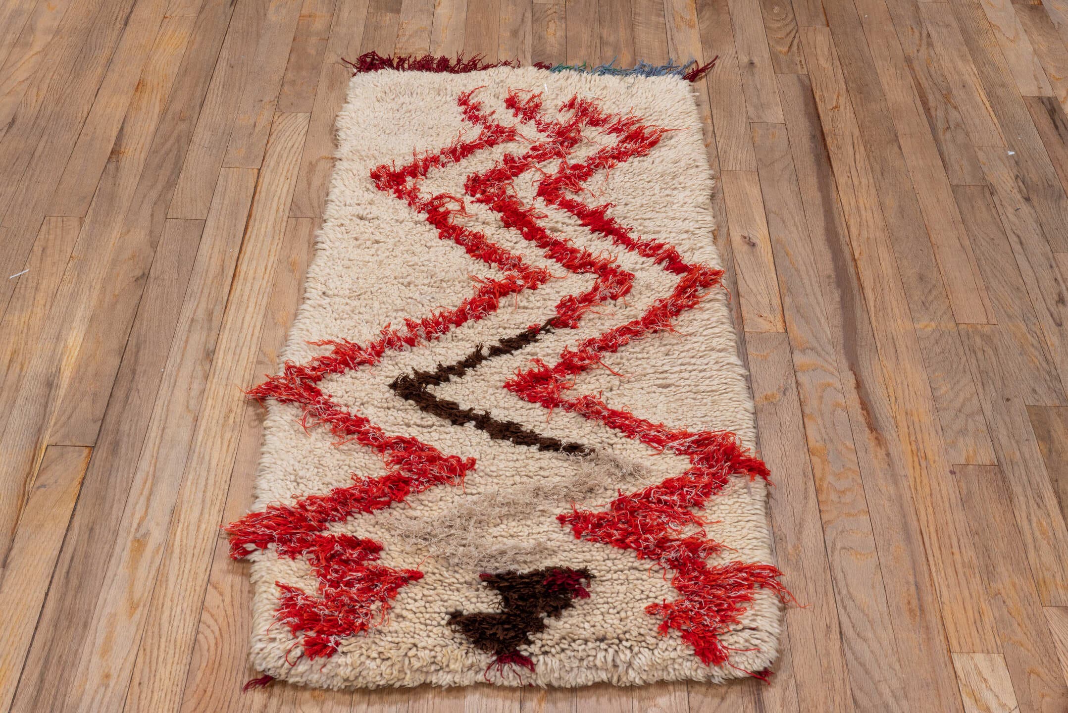 1' x 4' one-of-a-kind handmade vintage Moroccan small size rug. Color palette: ivory, crimson, brown, burgundy, blue, green