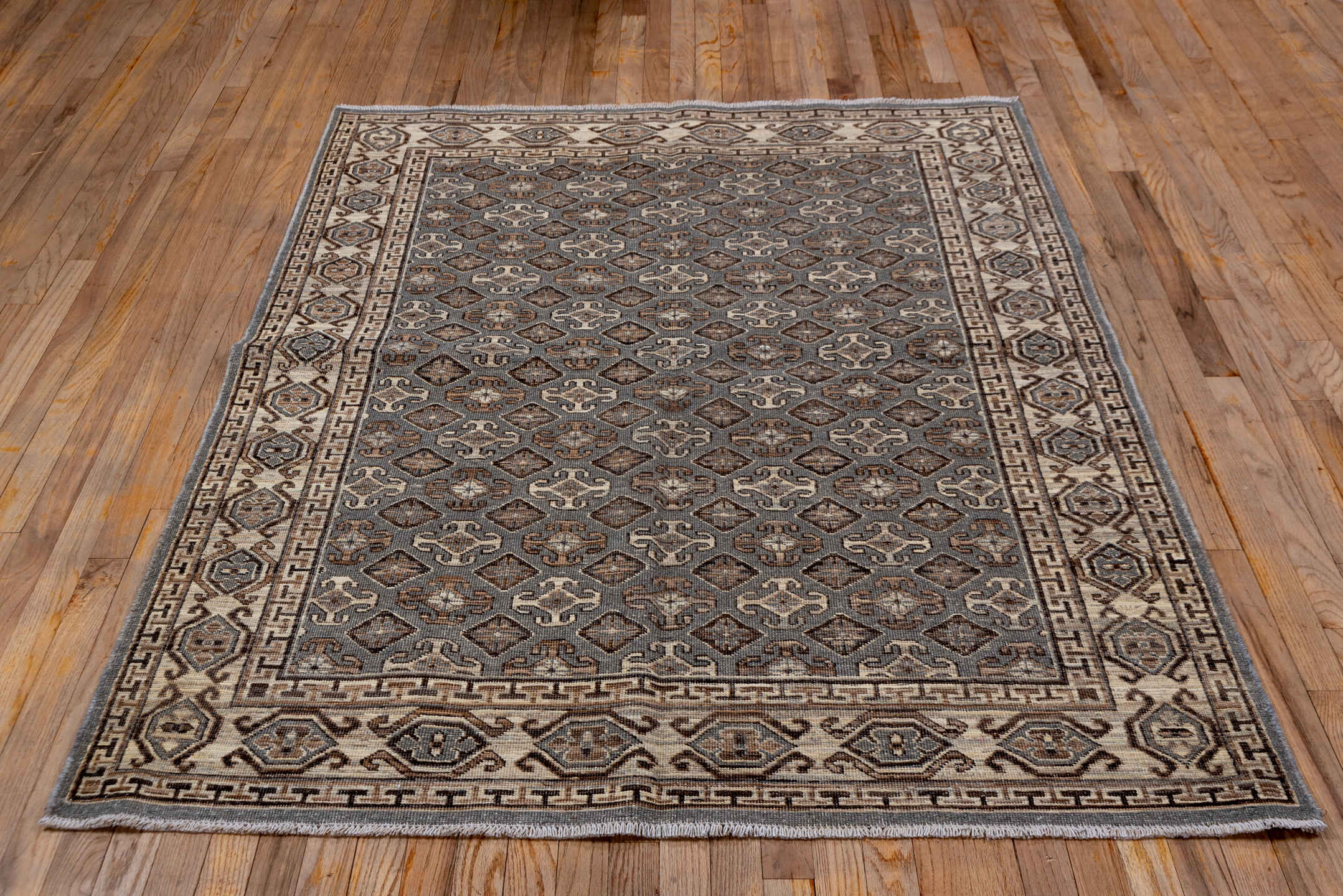 4' x 6' one-of-a-kind handmade vintage Khotan small size rug. Color palette: brown, dark gray, gray, light gray, off-white
