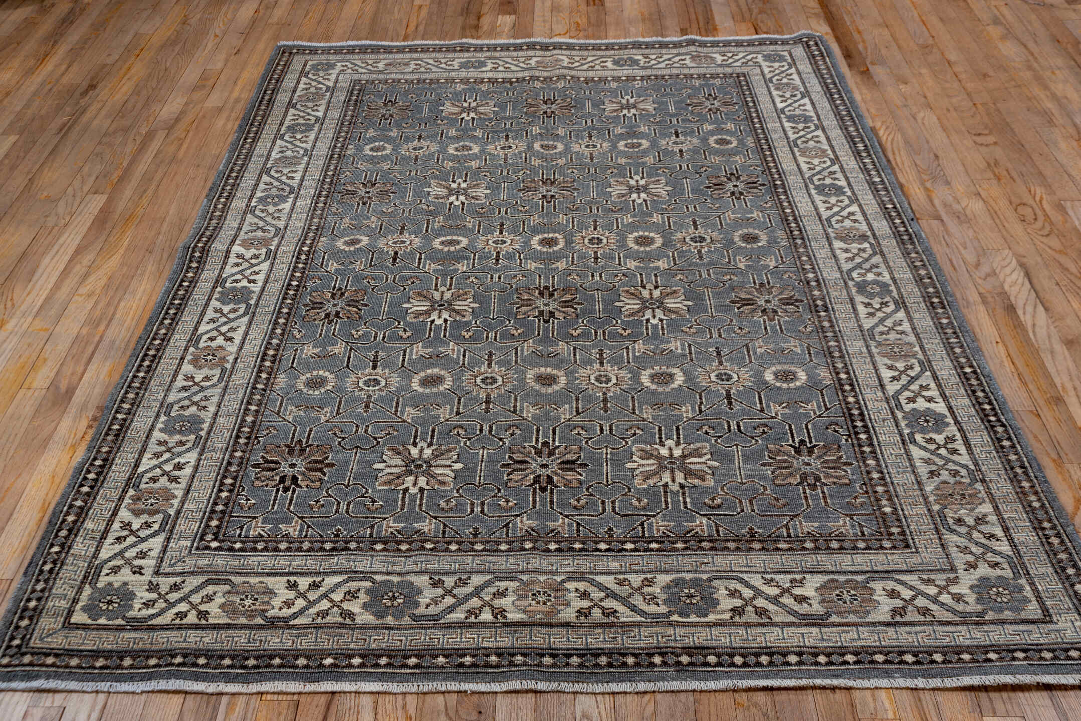 5' x 7' one-of-a-kind handmade vintage Khotan rug. Color palette: brown, dim gray, gray, light gray, off-white, pink