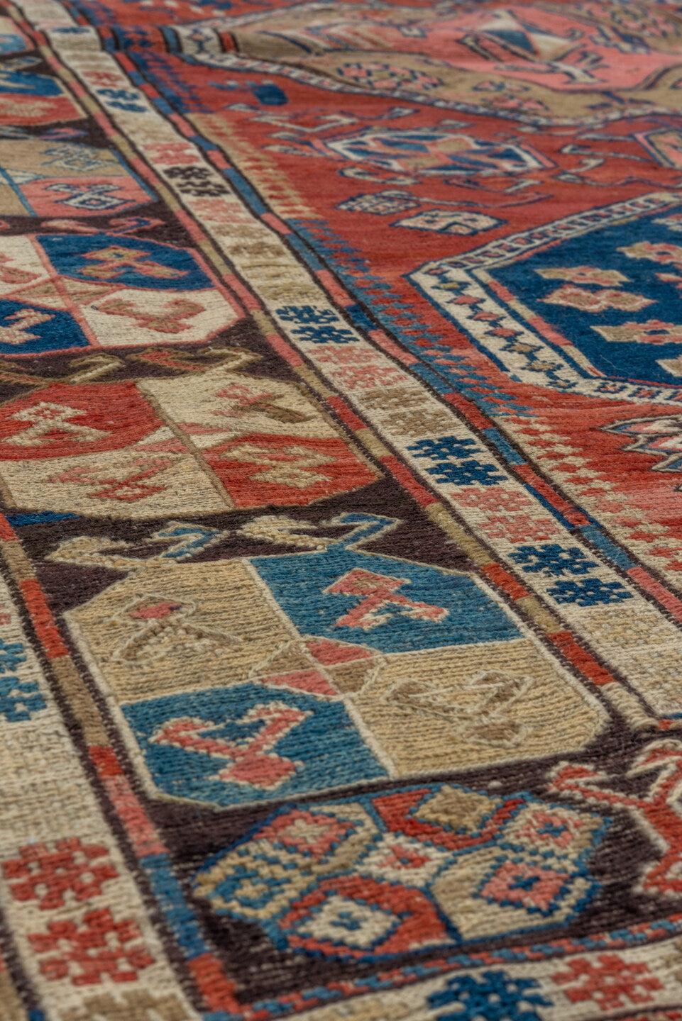 3' x 6' one-of-a-kind handmade antique Sumak small size rug. Color palette: rust, ivory, indigo, camel, charcoal, rose