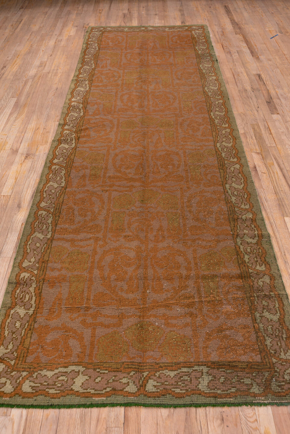 4' x 13' one-of-a-kind handmade handmade Donegal runner rug. Color palette: terra cotta, rust, taupe, olive, sage, brown