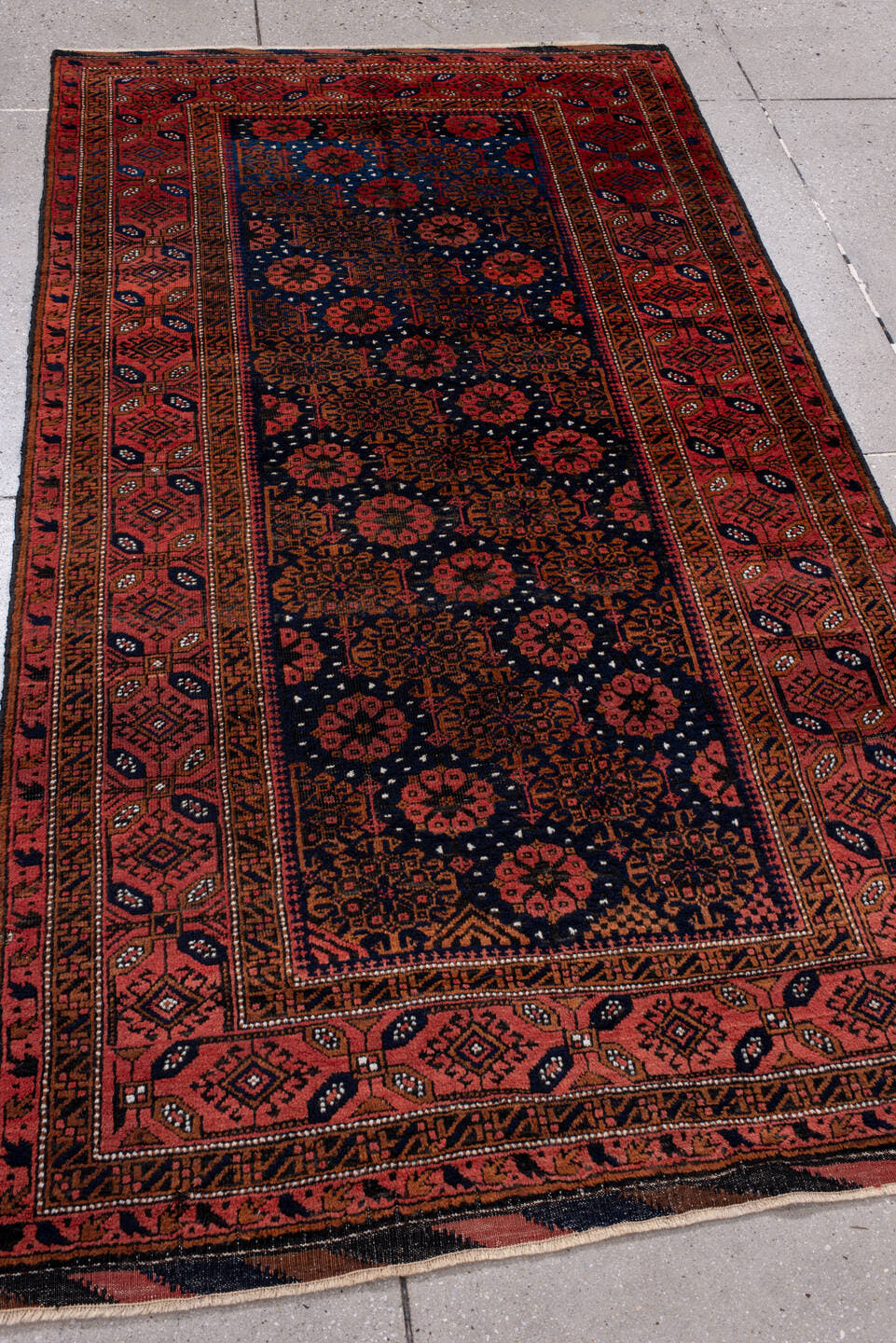 3' x 7' one-of-a-kind handmade antique Belouch rug. Color palette: rust, navy, terracotta, burgundy, camel, ivory, charcoal