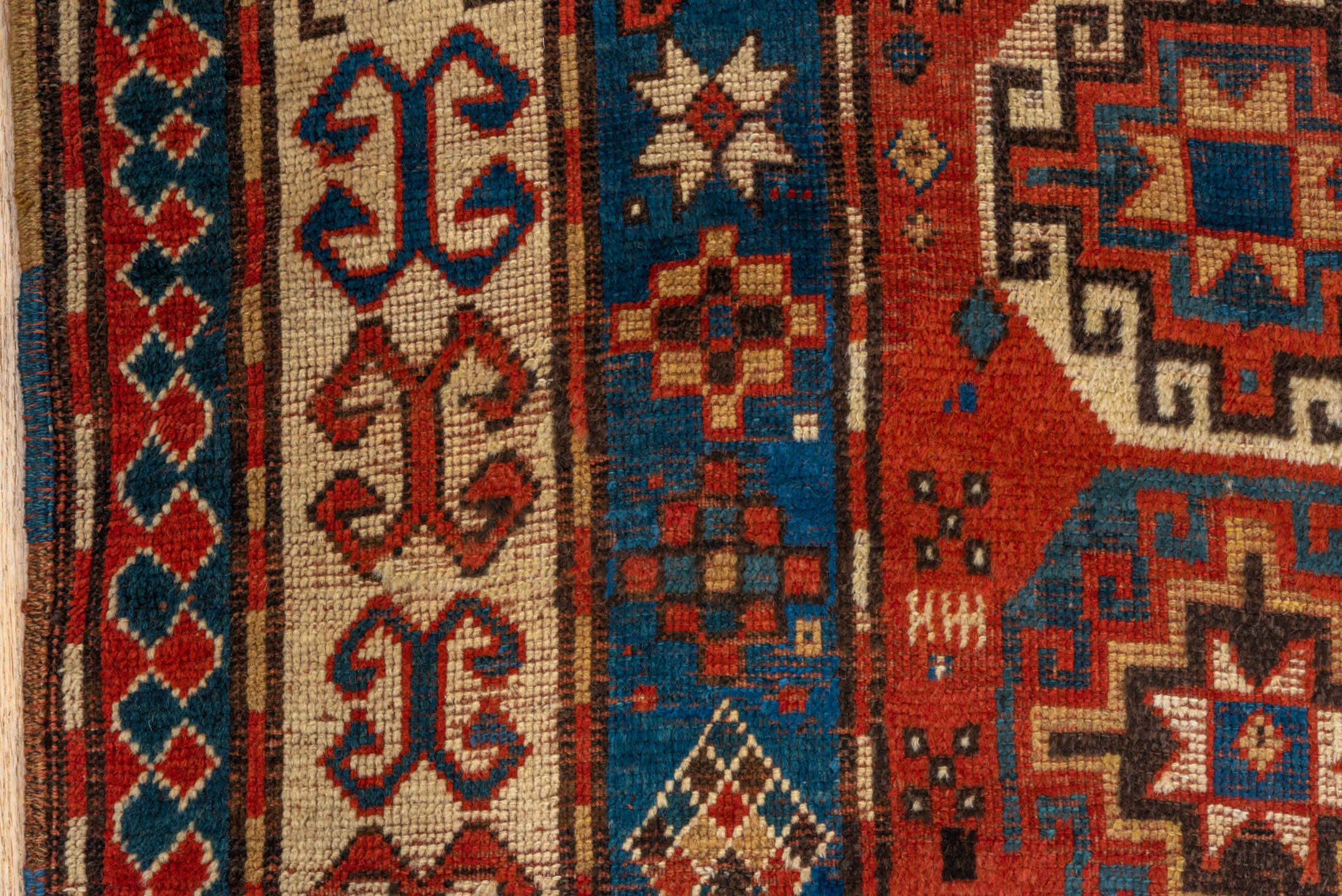 4' x 7' one-of-a-kind handmade antique Kazak rug. Color palette: rust, cobalt, ivory, camel, charcoal, gold, crimson