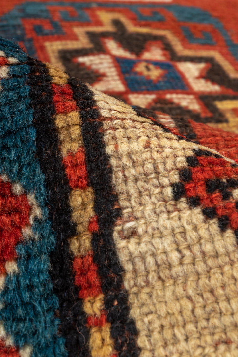 4' x 7' one-of-a-kind handmade antique Kazak rug. Color palette: rust, cobalt, ivory, camel, charcoal, gold, crimson