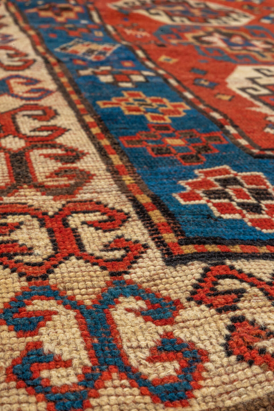 4' x 7' one-of-a-kind handmade antique Kazak rug. Color palette: rust, cobalt, ivory, camel, charcoal, gold, crimson