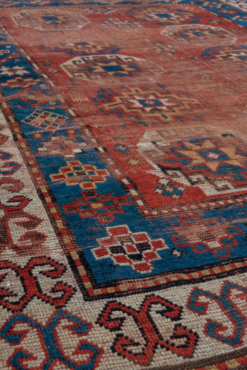 4' x 7' one-of-a-kind handmade antique Kazak rug. Color palette: rust, cobalt, ivory, camel, charcoal, gold, crimson