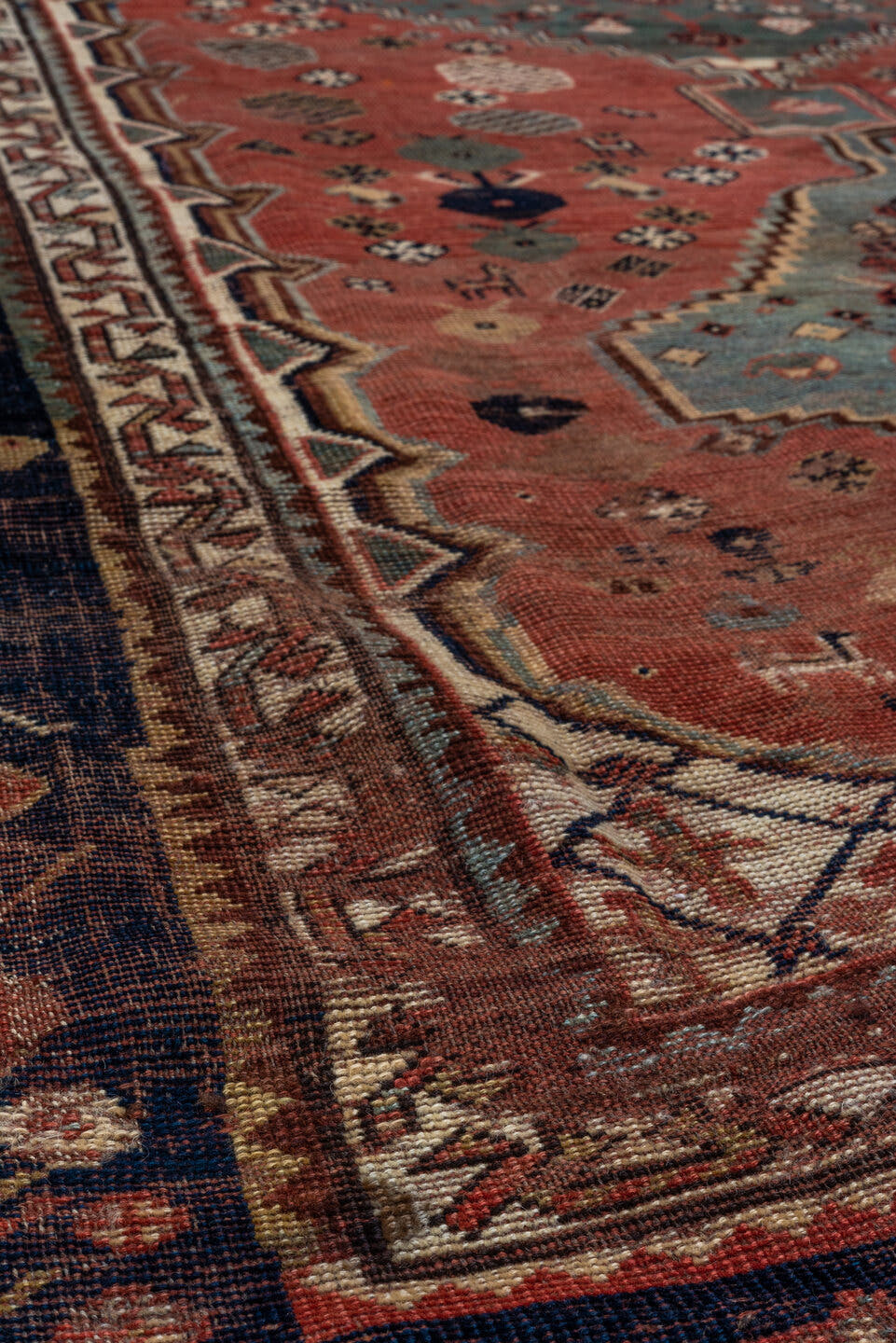 5' x 8' one-of-a-kind handmade antique Qashqai medium size rug. Color palette: rust, indigo, ivory, slate, terra cotta