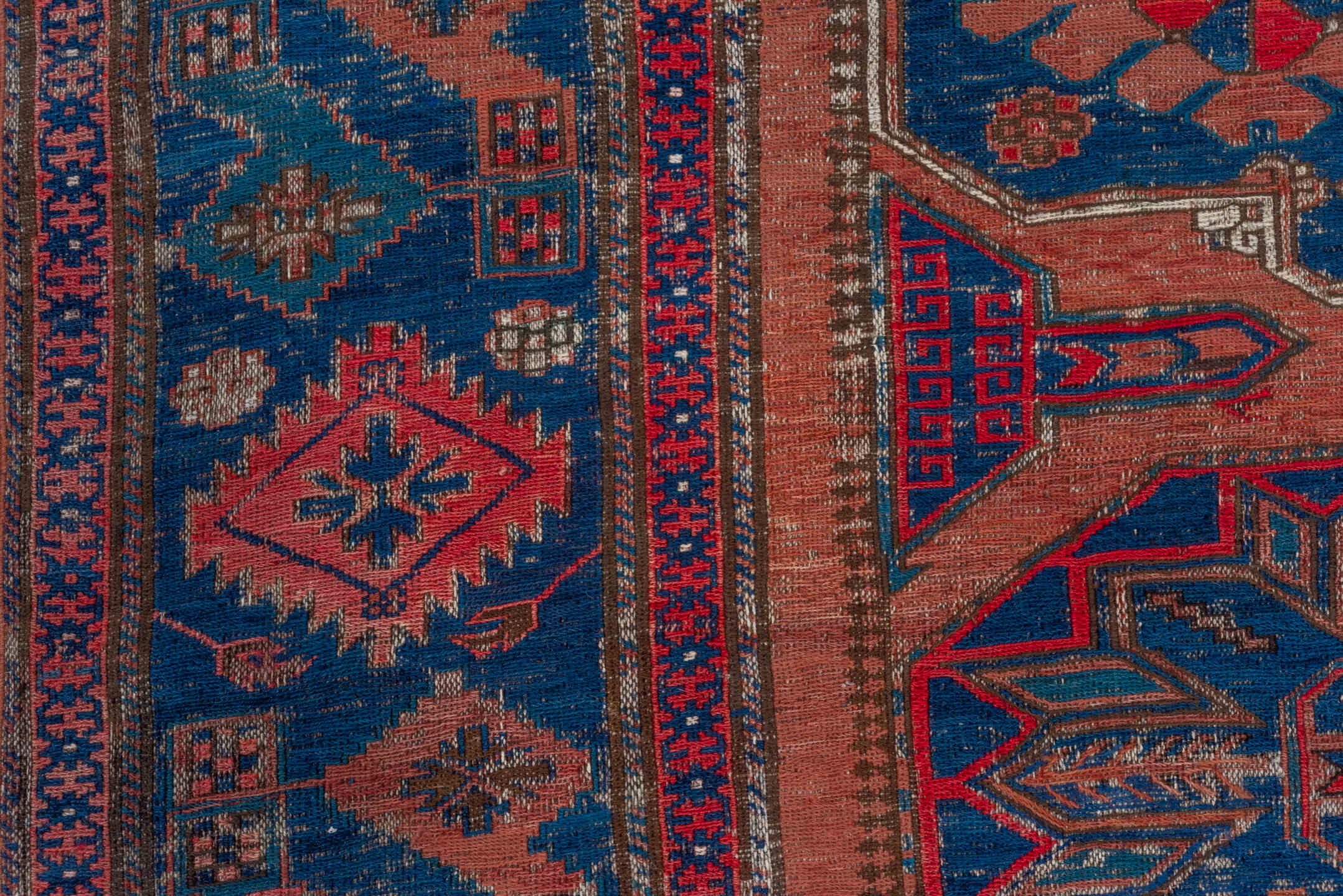 6' x 9' one-of-a-kind handmade antique Sumak medium size rug. Color palette: terra cotta, indigo, sky blue, rust, crimson