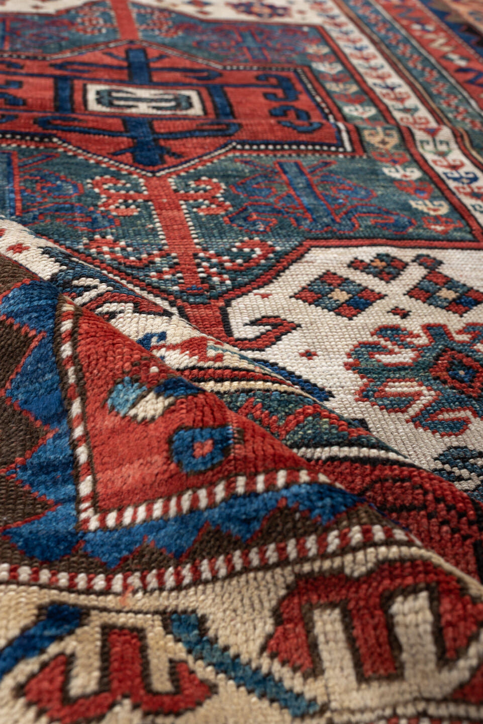 3' x 5' one-of-a-kind handmade antique Kazak small size rug. Color palette: terracotta, ivory, indigo, rust, sky_blue, navy