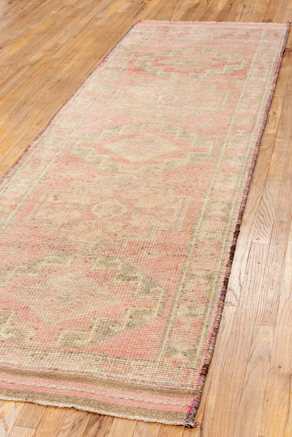 3' x 10' one-of-a-kind handmade vintage Kars runner rug. Color palette: brown, off-white, orange, pink, red, snow, white