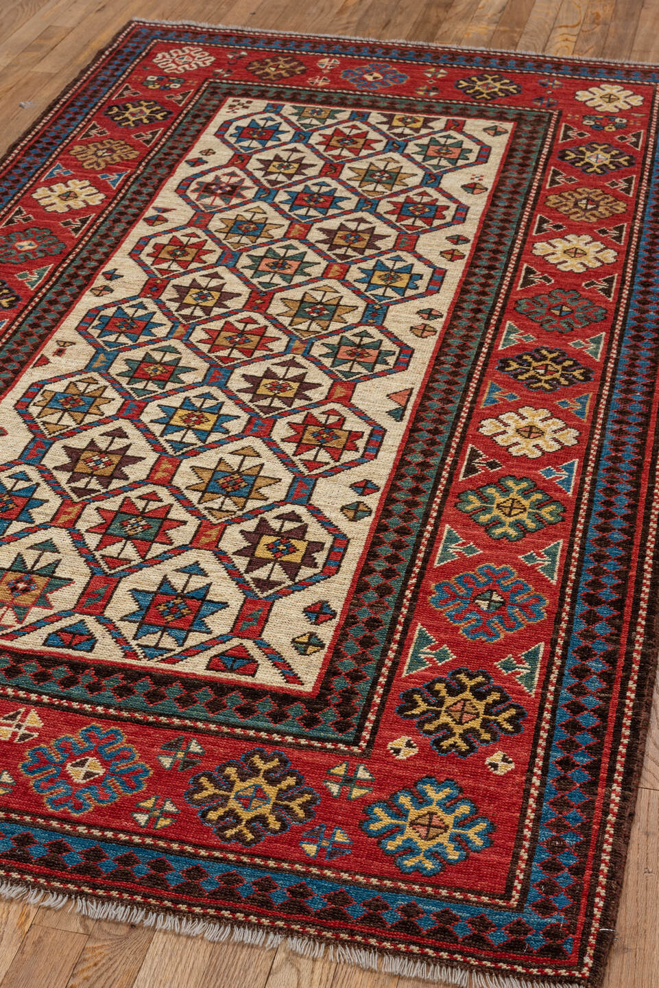4' x 7' one-of-a-kind handmade vintage Kazak rug. Color palette: red, ivory, sky blue, navy, camel, brown, black, sage