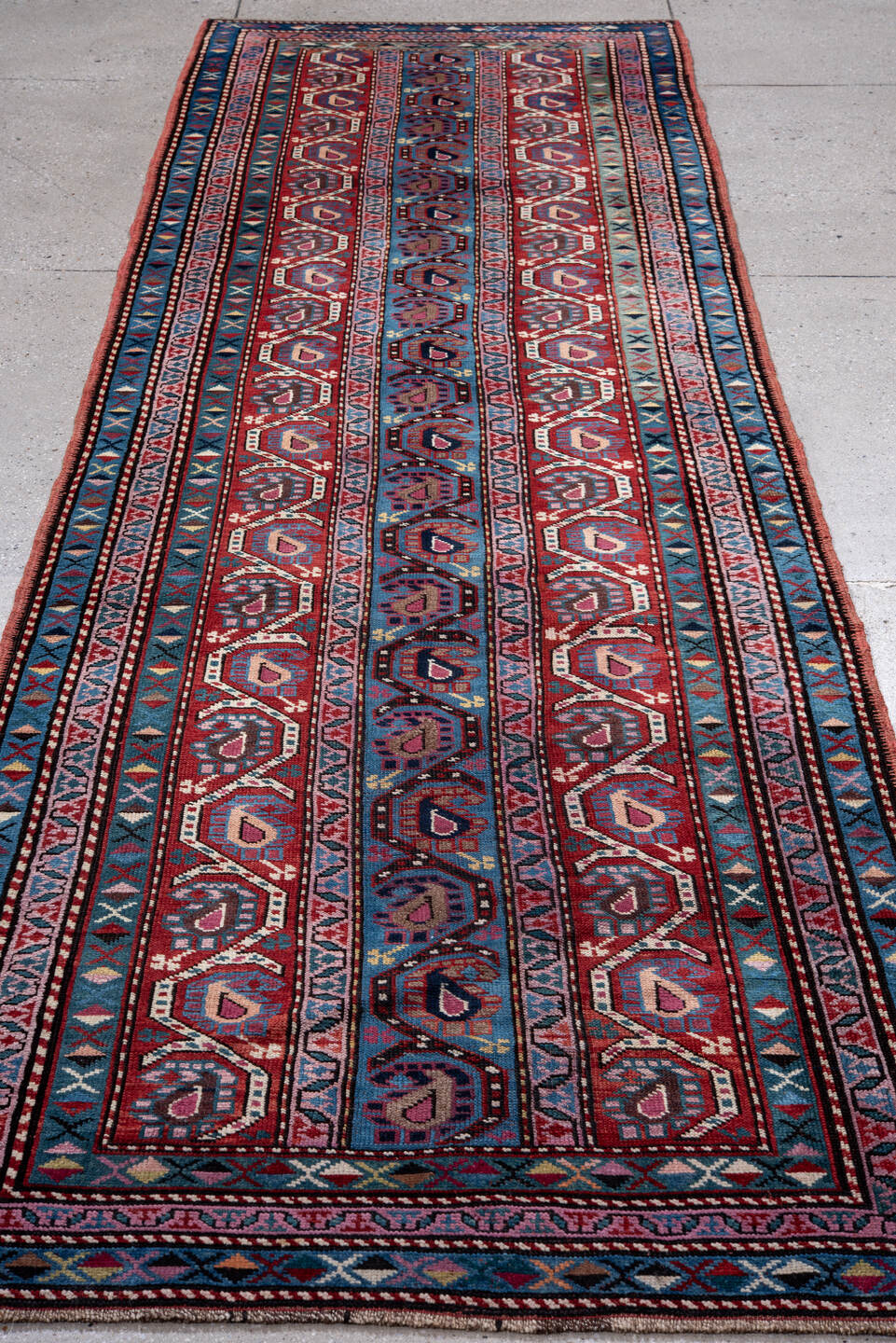 3' x 11' one-of-a-kind handmade vintage Caucasian runner rug. Color palette: gray, blue, red, brown, pink, black, light gray