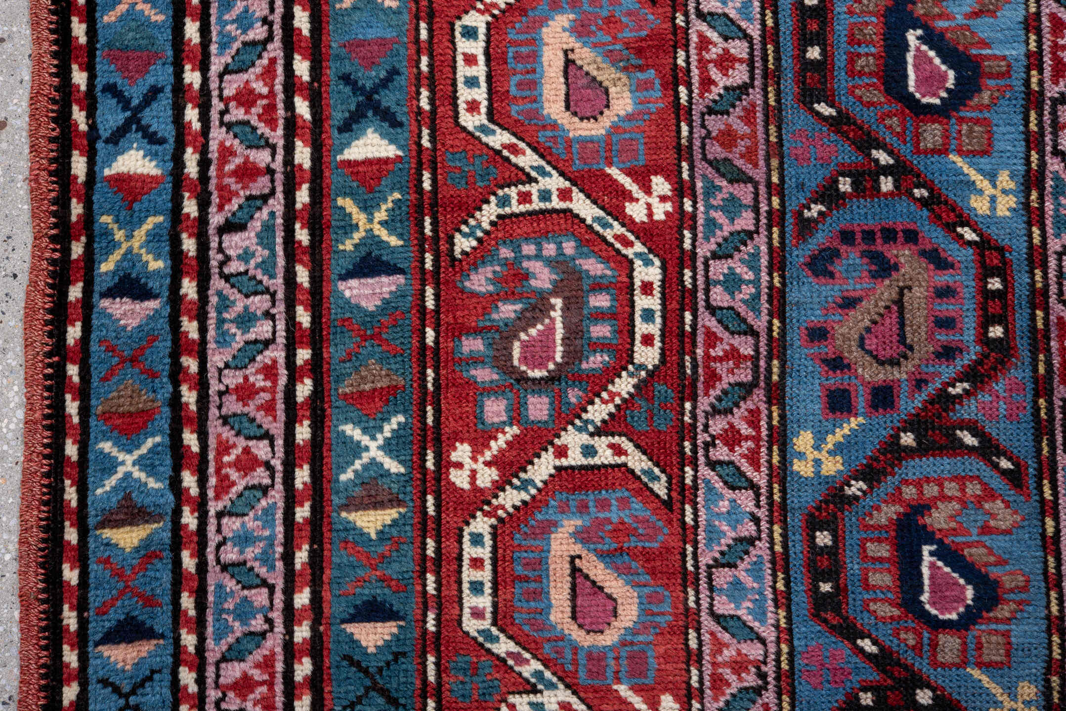 3' x 11' one-of-a-kind handmade vintage Caucasian runner rug. Color palette: black, blue, brown, fiord, gray, indian red