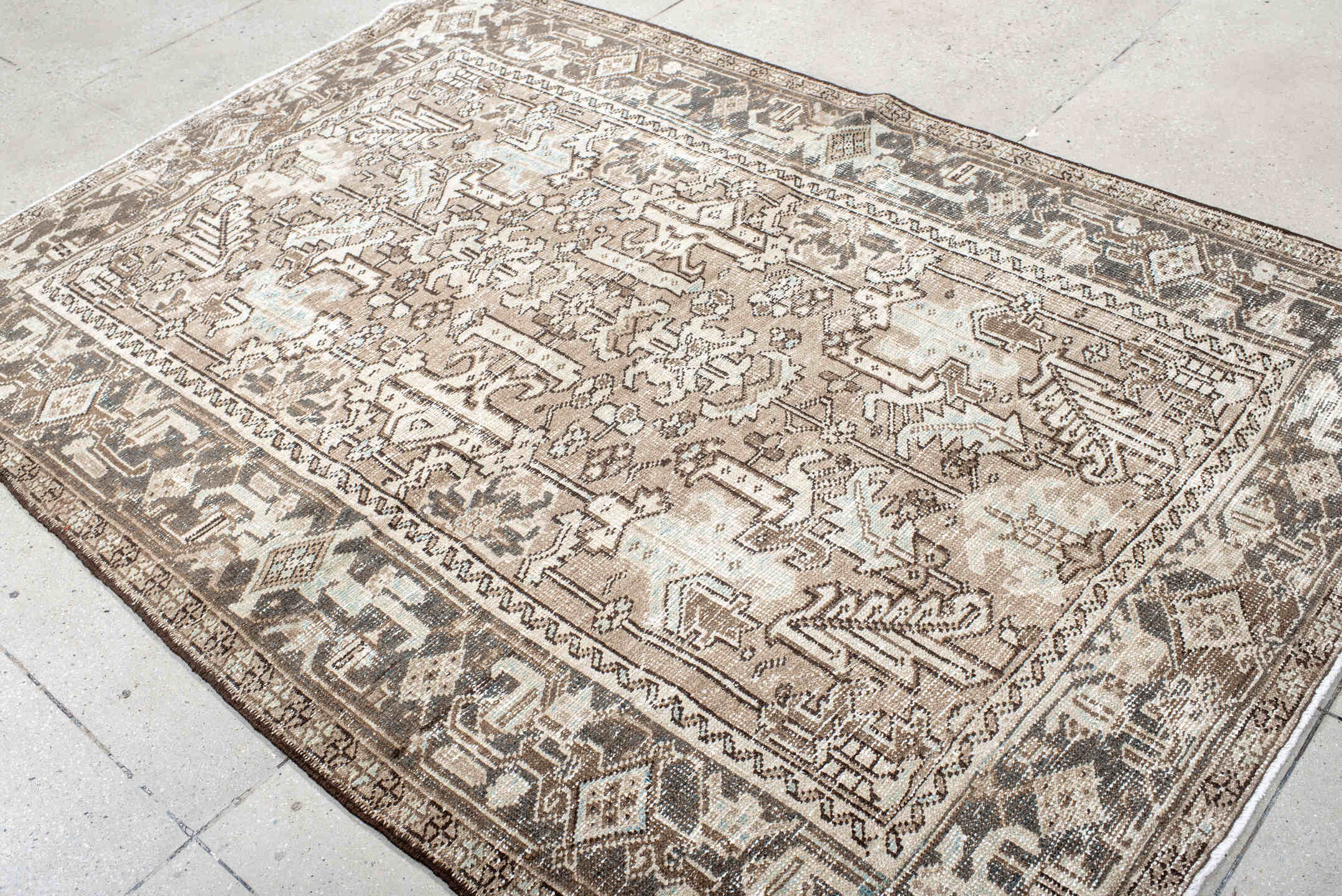 5' x 8' one-of-a-kind handmade antique Heriz medium size rug. Color palette: taupe, ivory, charcoal, brown, pale blue, cream