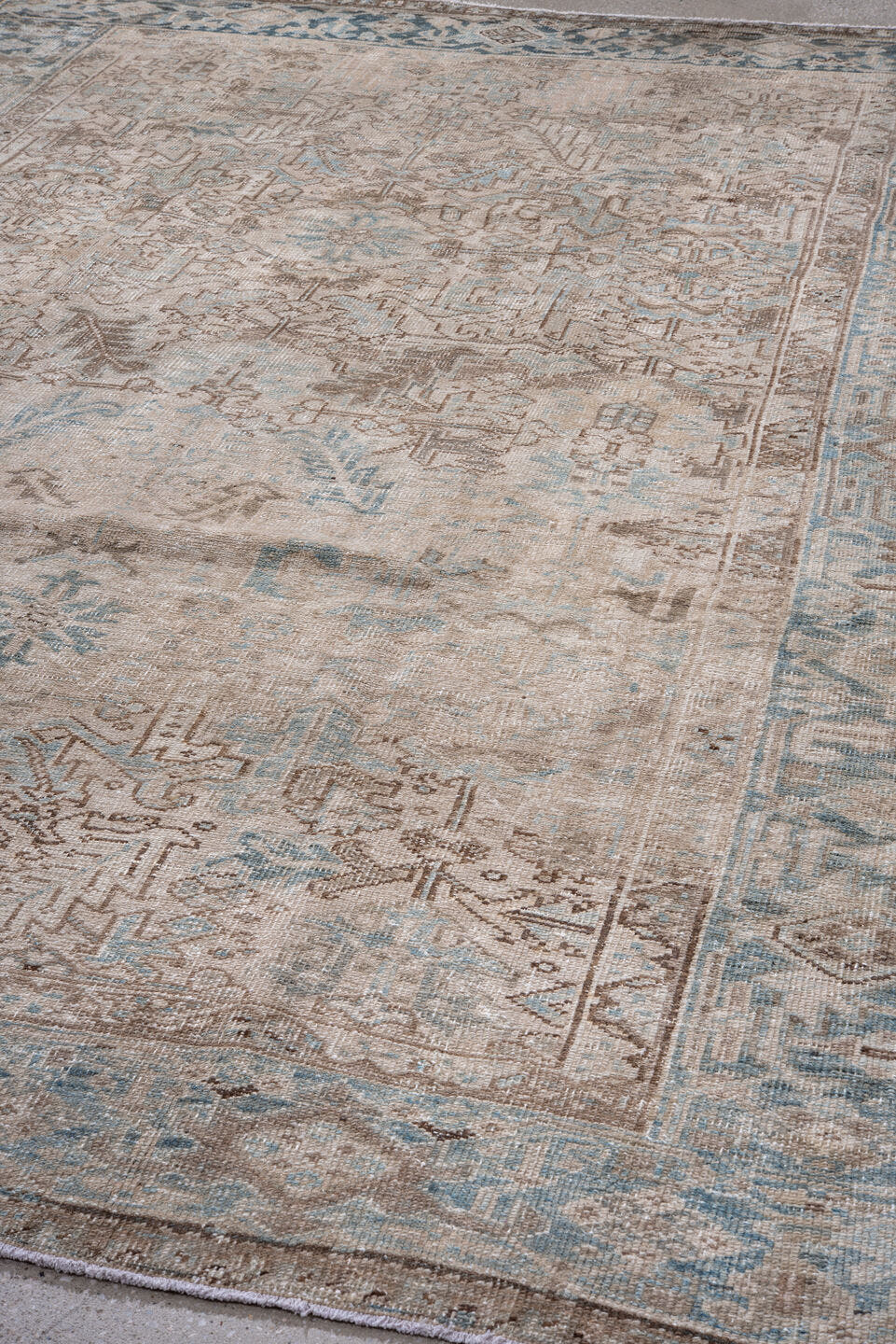 7' x 10' one-of-a-kind handmade antique Heriz large size rug. Color palette: ivory, sky blue, taupe, beige, camel, brown