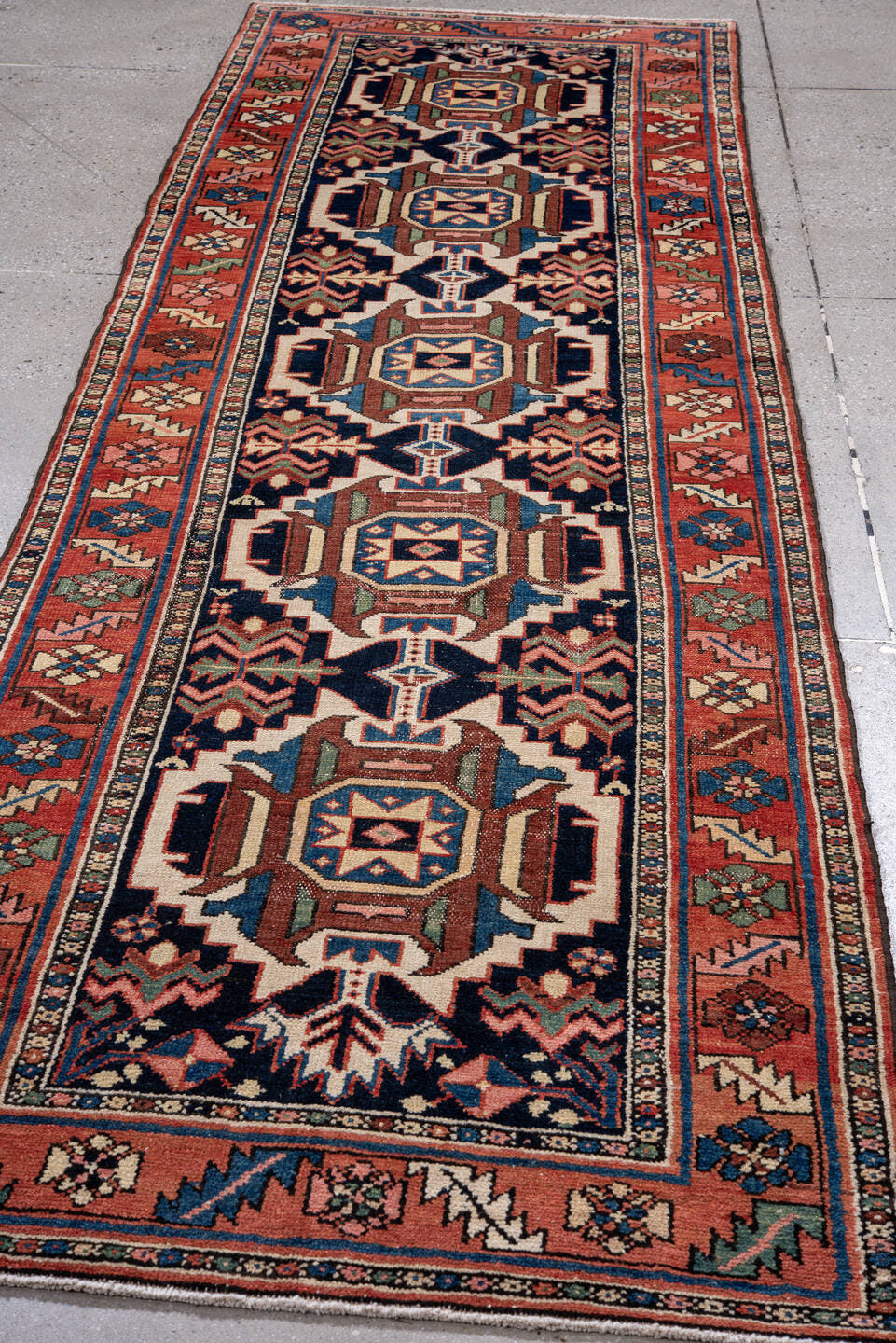 3' x 10' one-of-a-kind handmade antique Karaje runner rug. Color palette: navy, rust, ivory, sky blue, rose, sage, camel