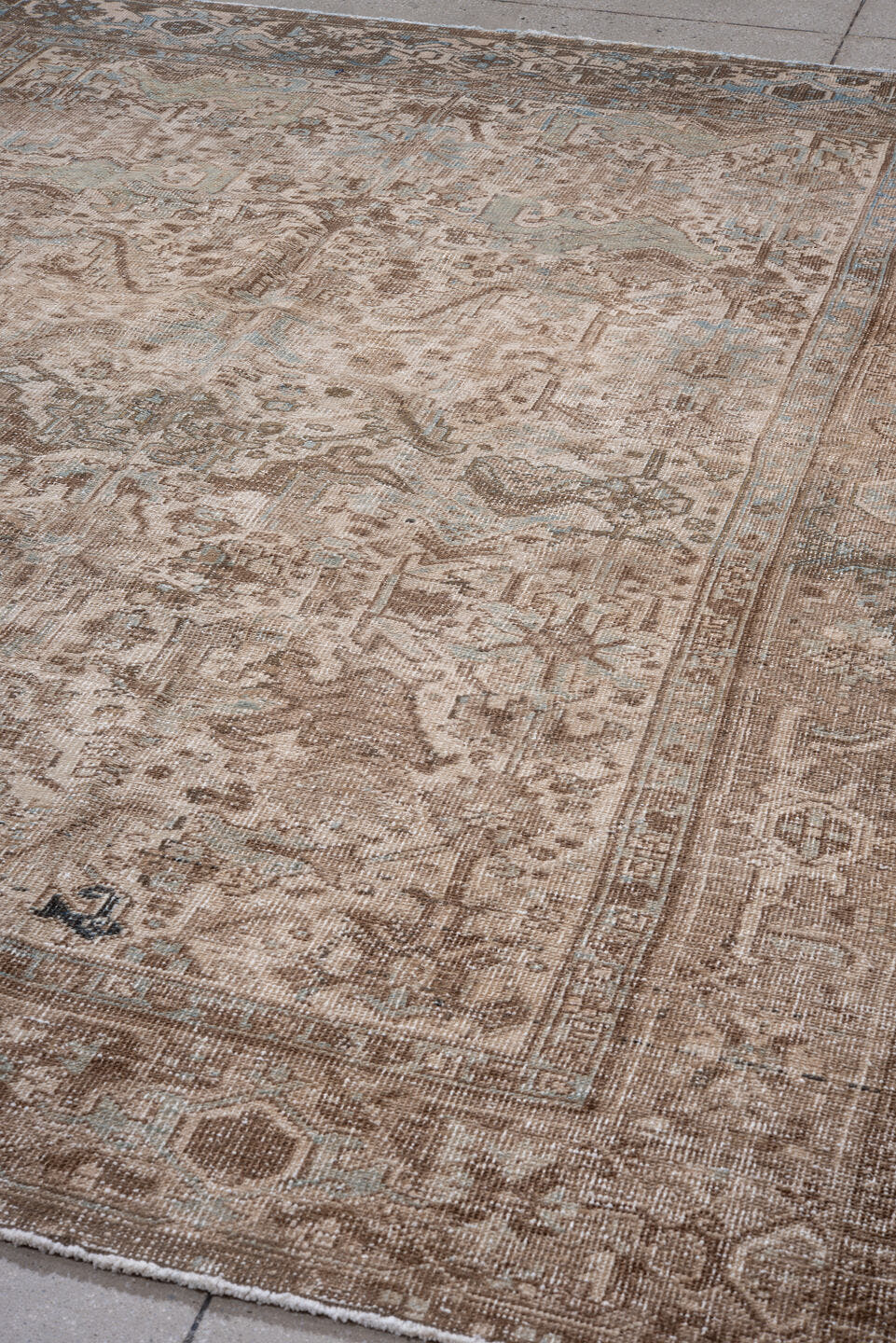 7' x 9' one-of-a-kind handmade antique Heriz rug. Color palette: taupe, brown, ivory, pale blue, beige, gray, light blue