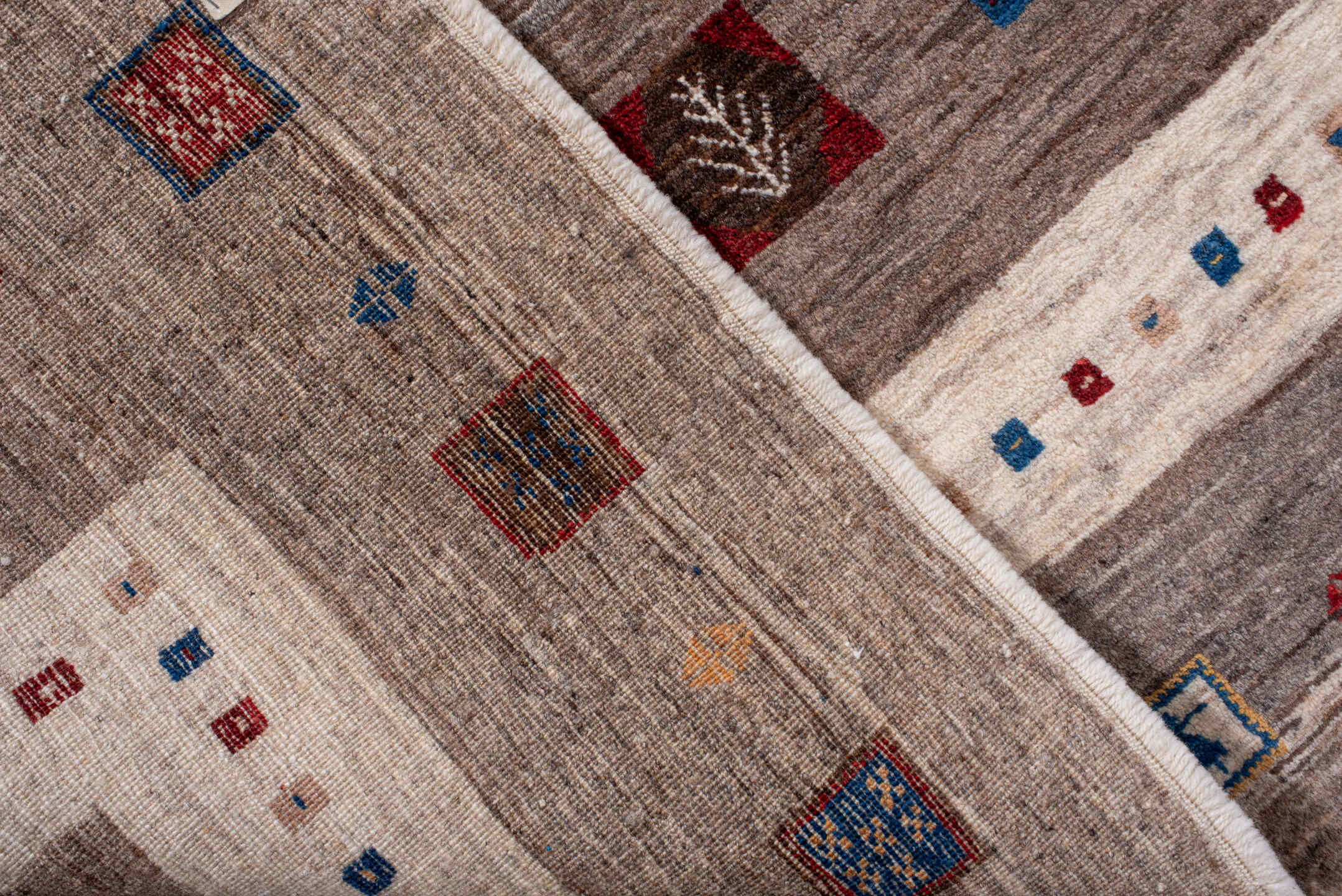 7' x 9' one-of-a-kind handmade vintage Gabbe rug. Color palette: ivory, taupe, brown, indigo, burgundy, gold, camel, beige