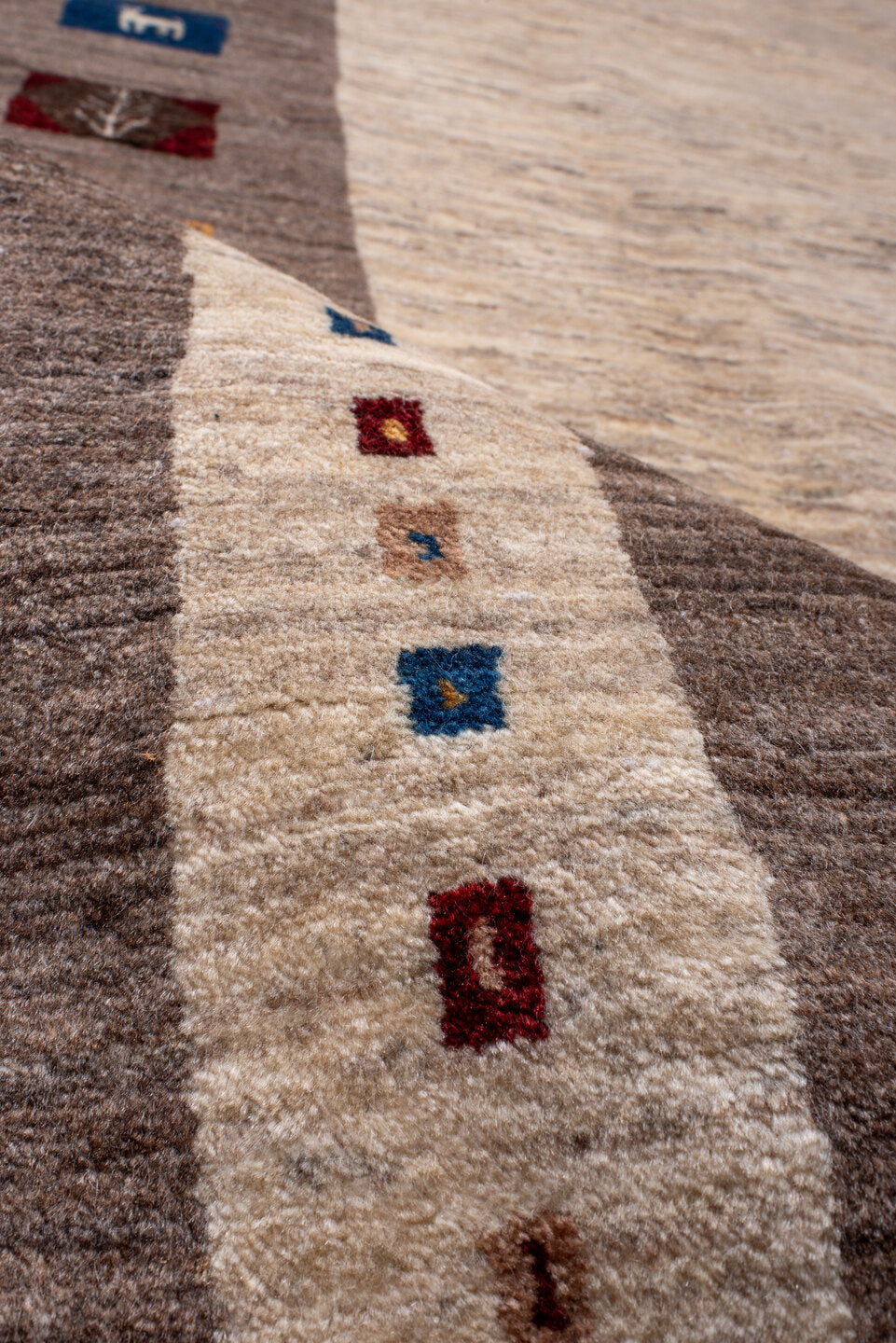 7' x 9' one-of-a-kind handmade vintage Gabbe rug. Color palette: ivory, taupe, brown, indigo, burgundy, gold, camel, beige