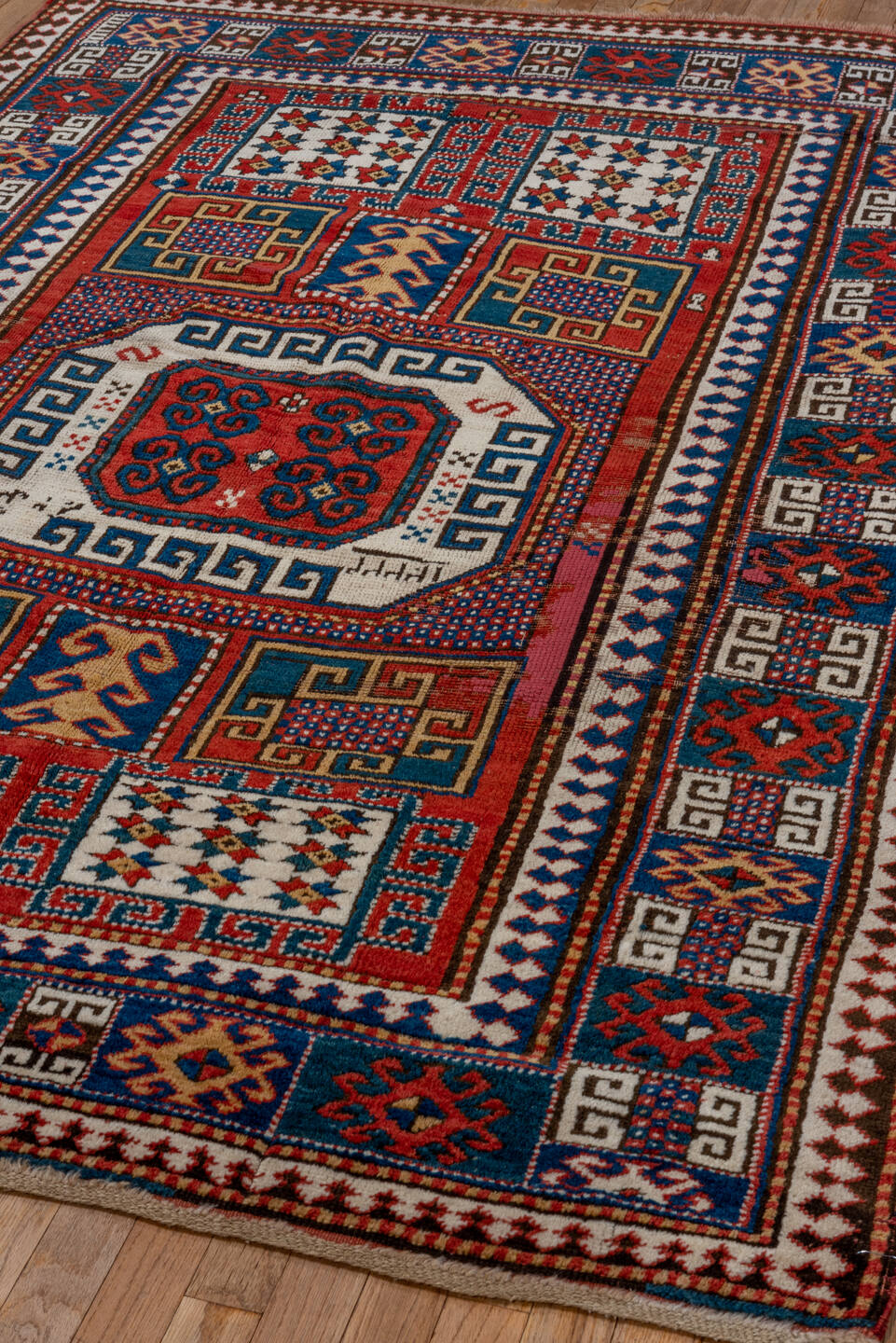 5' x 7' one-of-a-kind handmade vintage Kazak rug. Color palette: blue, brown, gray, pink, red