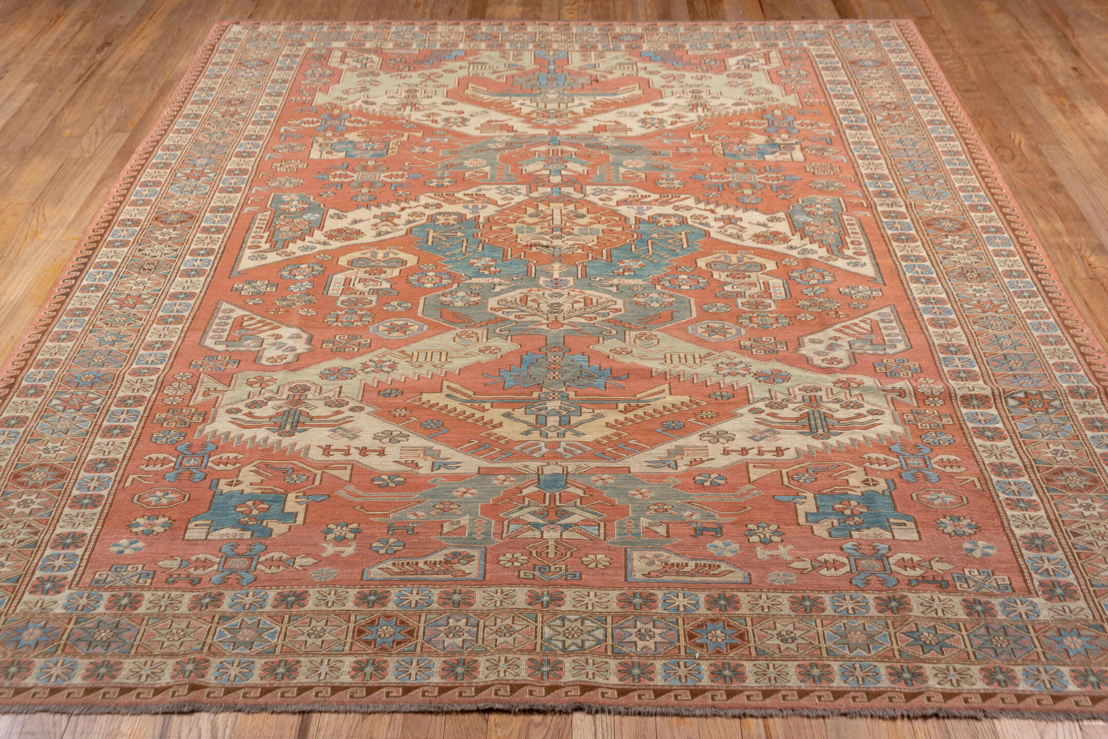 7' x 9' one-of-a-kind handmade vintage Sumak rug. Color palette: salmon, ivory, dusty blue, taupe, rust, beige, pink, blue