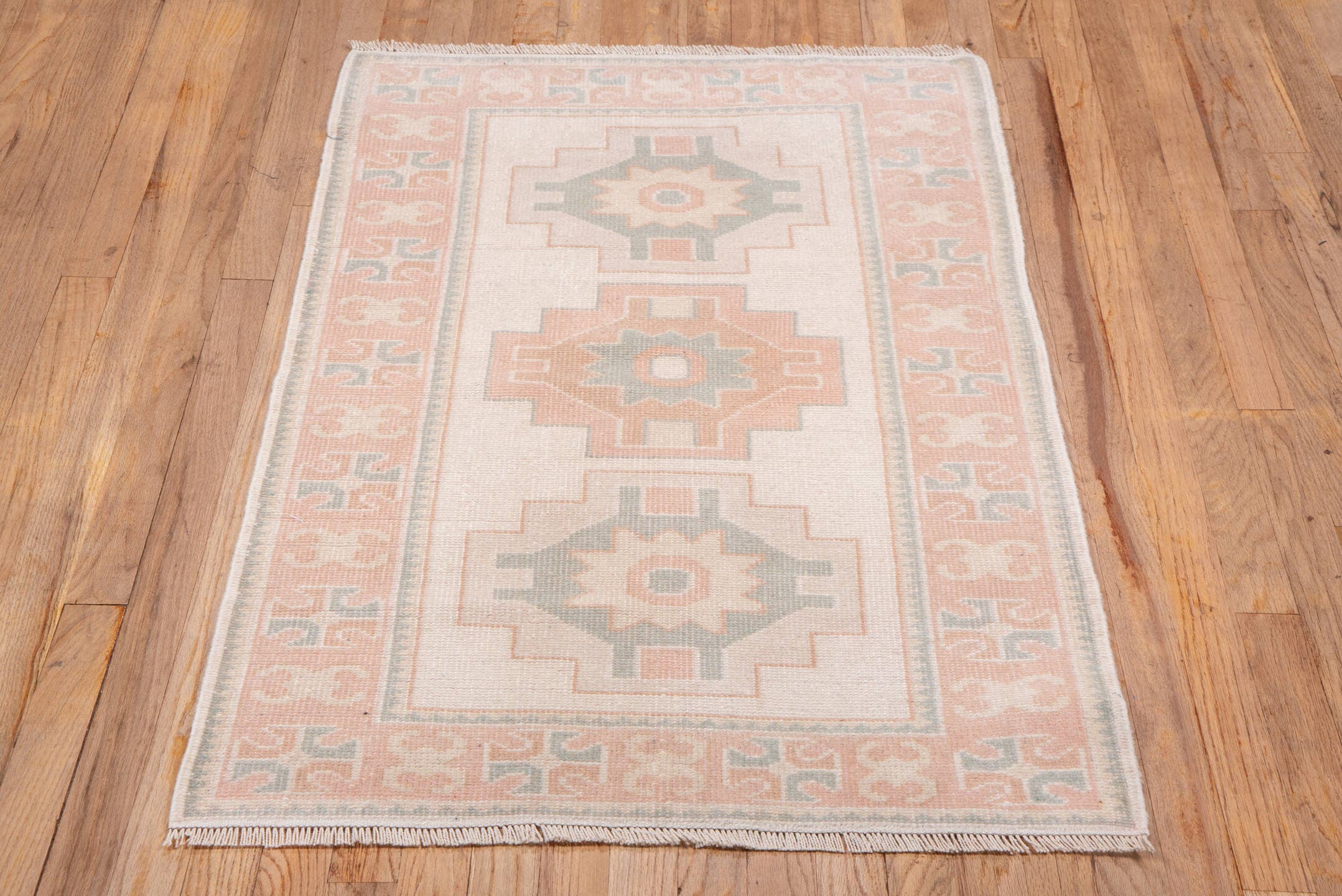 2' x 4' one-of-a-kind handmade vintage Oushak small size rug. Color palette: ivory, blush, peach, sage, taupe, pink