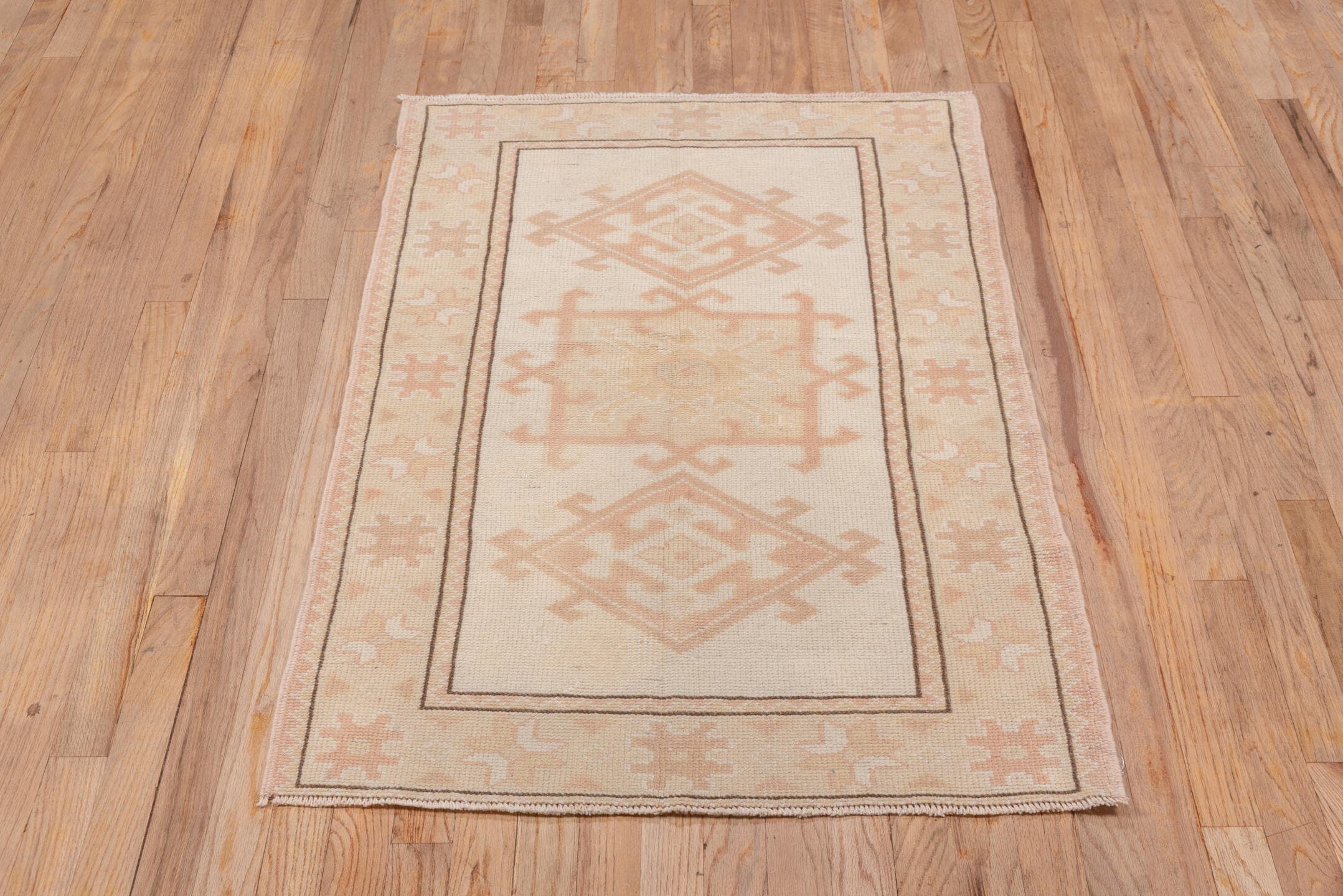 2' x 4' one-of-a-kind handmade vintage Oushak small size rug. Color palette: ivory, blush, peach, taupe, camel, pink