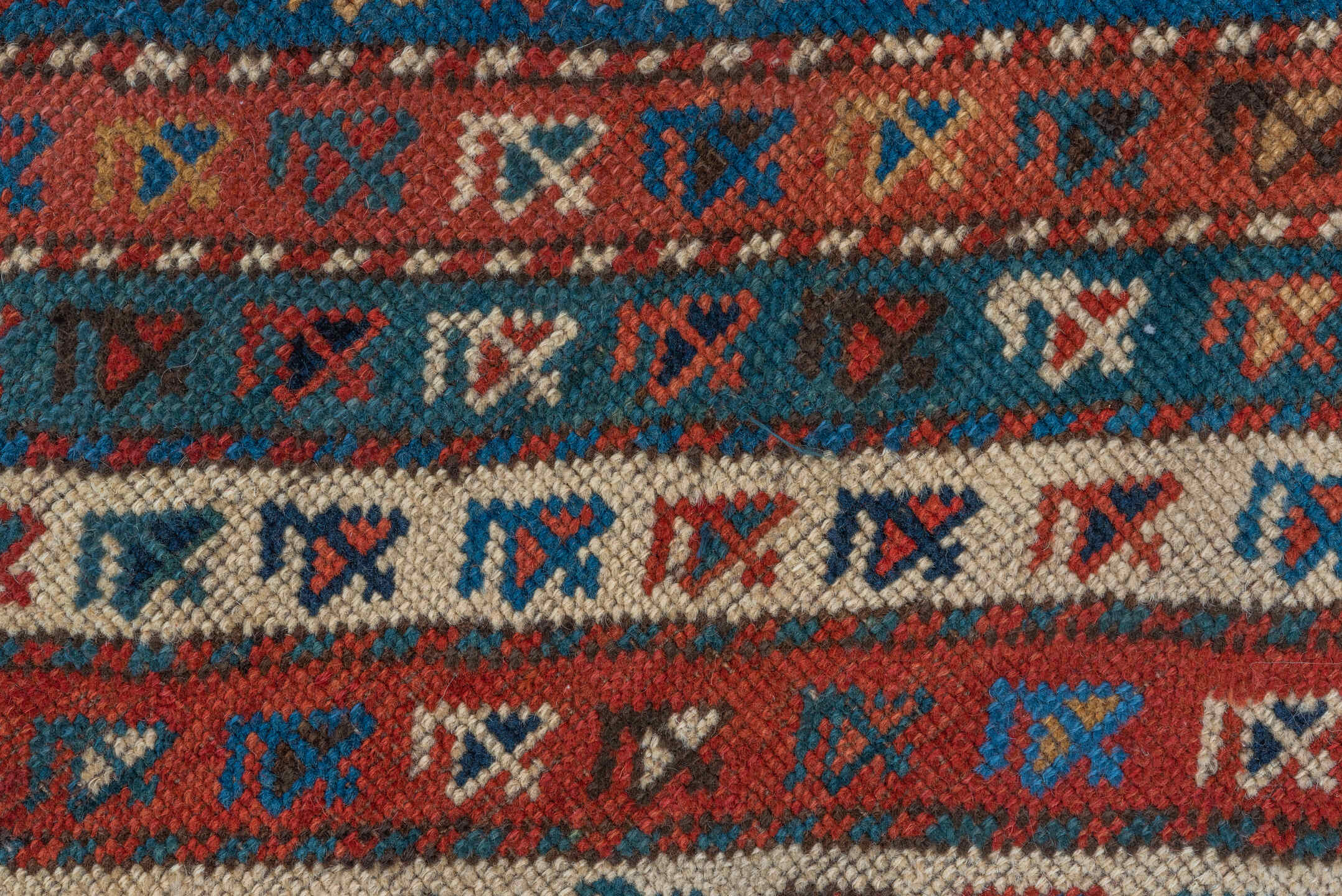 4' x 9' one-of-a-kind handmade antique Kazak runner rug. Color palette: rust, ivory, blue, navy, camel, crimson, charcoal