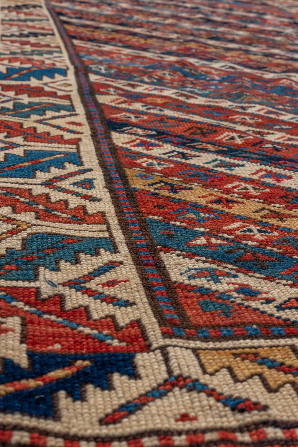 4' x 9' one-of-a-kind handmade antique Kazak runner rug. Color palette: rust, ivory, blue, navy, camel, crimson, charcoal