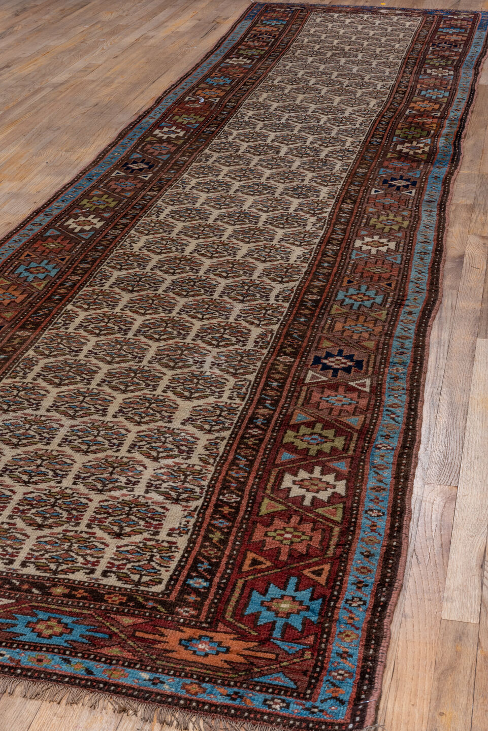 3' x 16' one-of-a-kind handmade vintage Kurd runner rug. Color palette: ivory, rust, brown, sky_blue, indigo, camel, navy