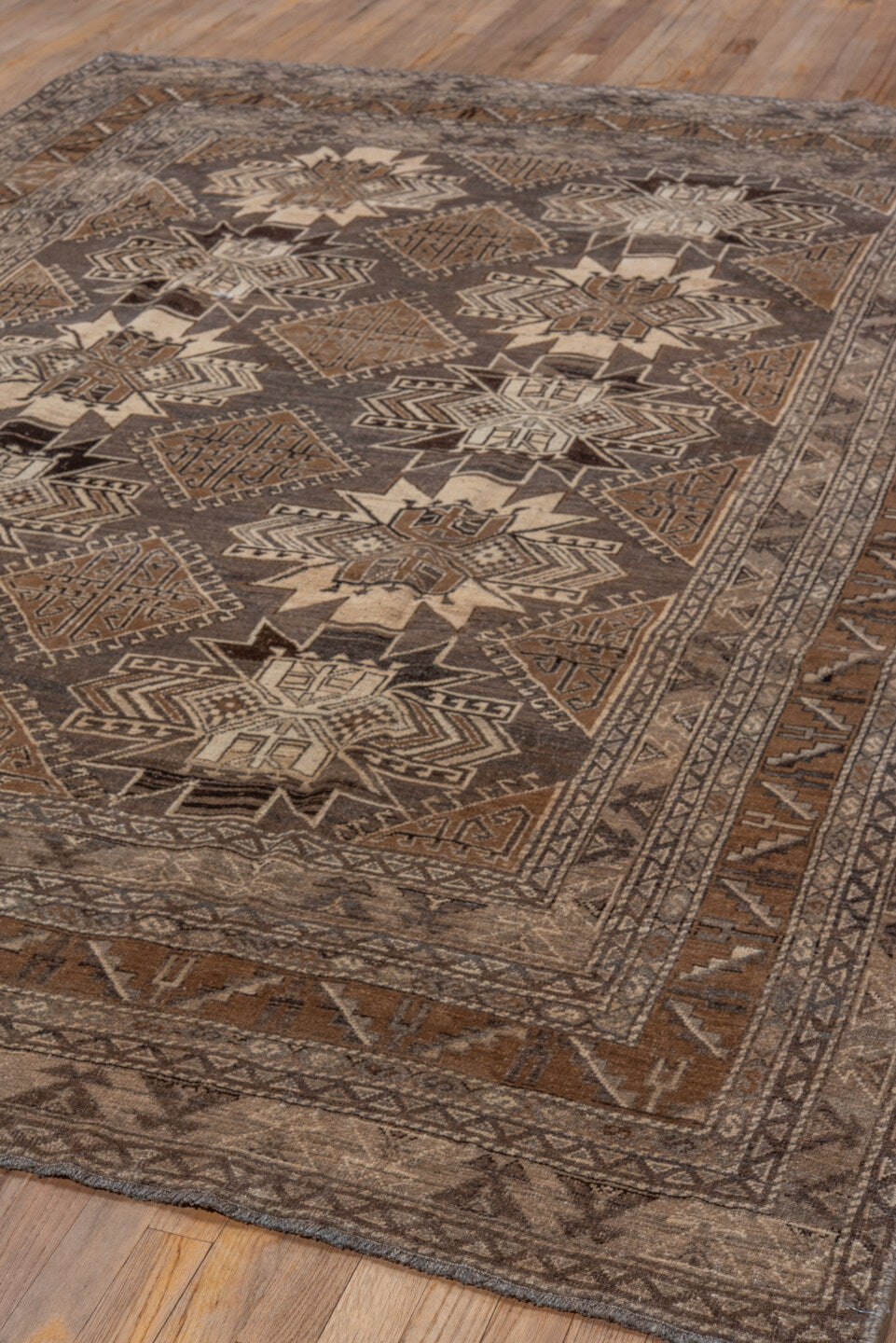 7' x 9' one-of-a-kind handmade vintage Afghan rug. Color palette: black, brown, charcoal, gray, light gray, off-white, pink