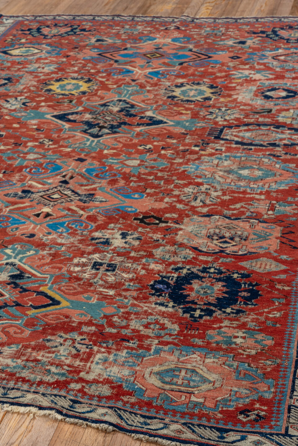 5' x 7' one-of-a-kind handmade vintage Sumak rug. Color palette: black, blue, brown, charcoal, dark gray, gray, pink, red