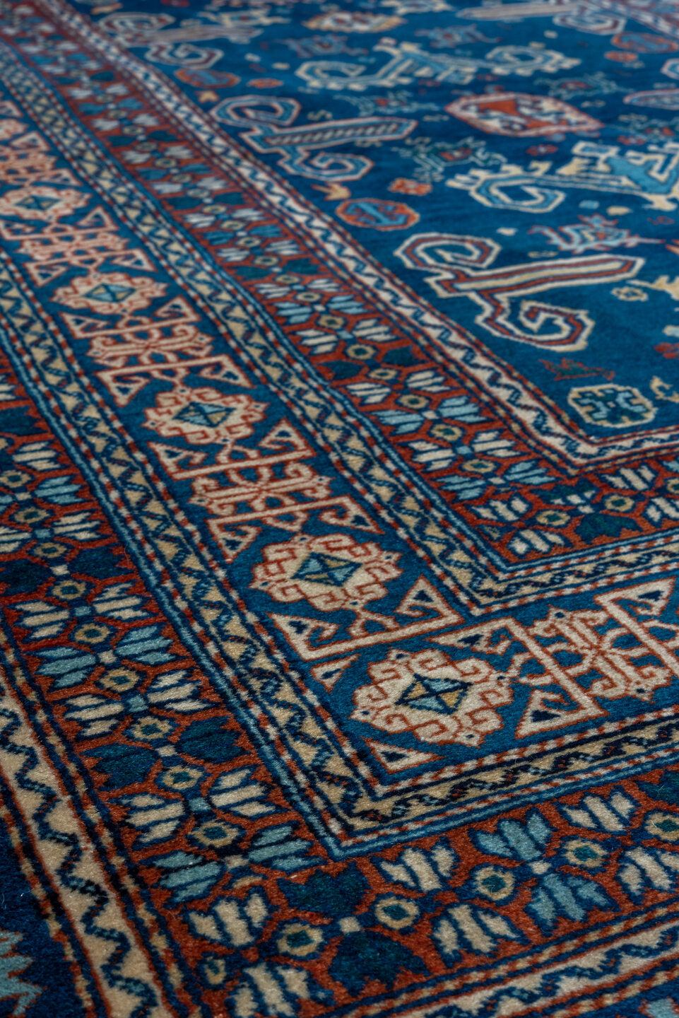 4' x 5' one-of-a-kind handmade vintage Shirvan small size rug. Color palette: navy, ivory, rust, sky_blue, crimson, camel