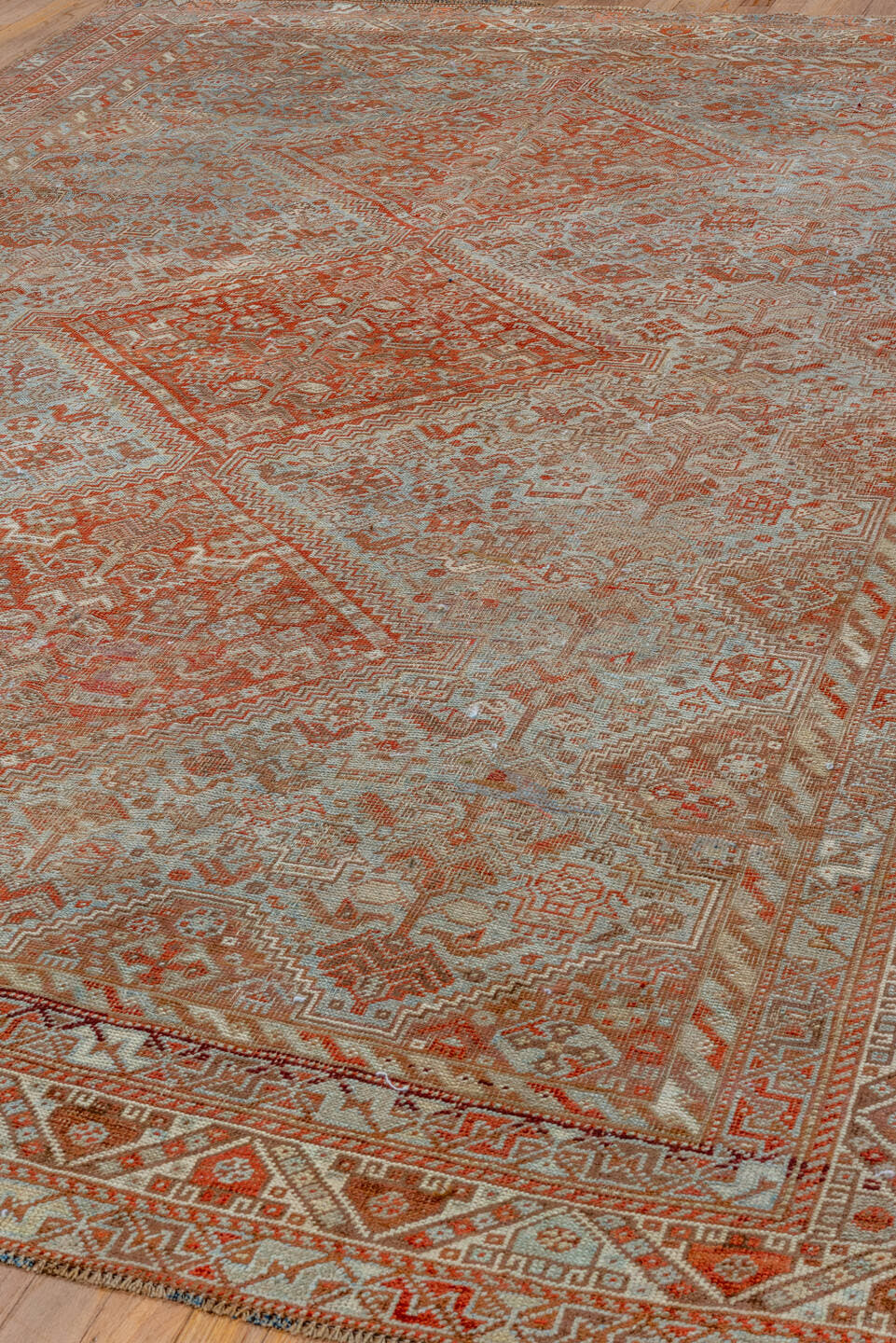 7' x 10' one-of-a-kind handmade vintage Shiraz large size rug. Color palette: rust, ivory, terra cotta, sky blue, camel