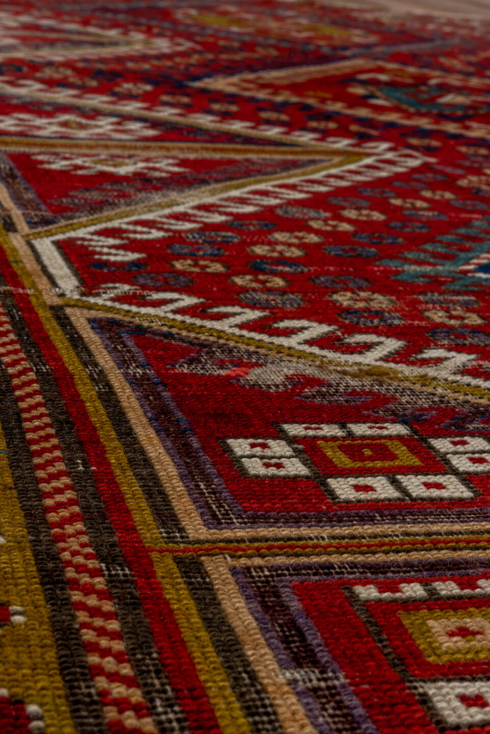5' x 7' one-of-a-kind handmade vintage Kazak rug. Color palette: black, brown, gray, red, redwood