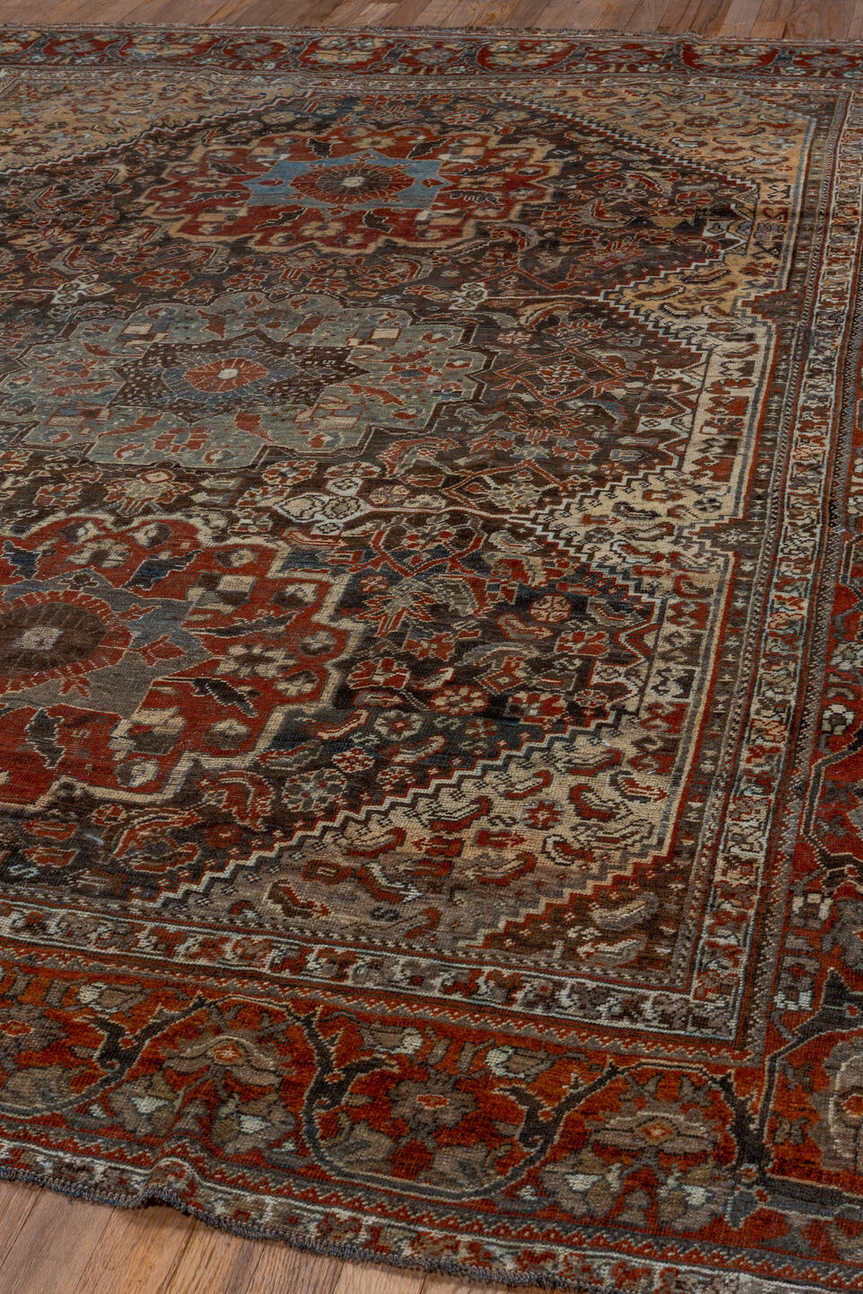 7' x 9' one-of-a-kind handmade vintage Shiraz rug. Color palette: rust, ivory, charcoal, slate, terracotta, brown, sky_blue