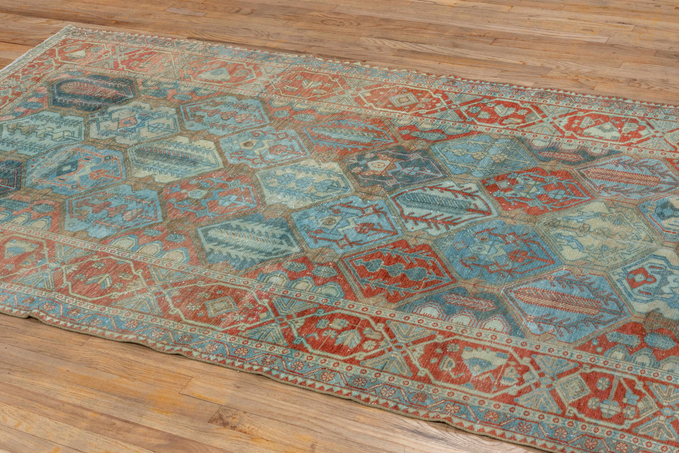 5' x 10' one-of-a-kind handmade vintage Baktiary runner rug. Color palette: rust, sky blue, ivory, camel, teal, terra cotta