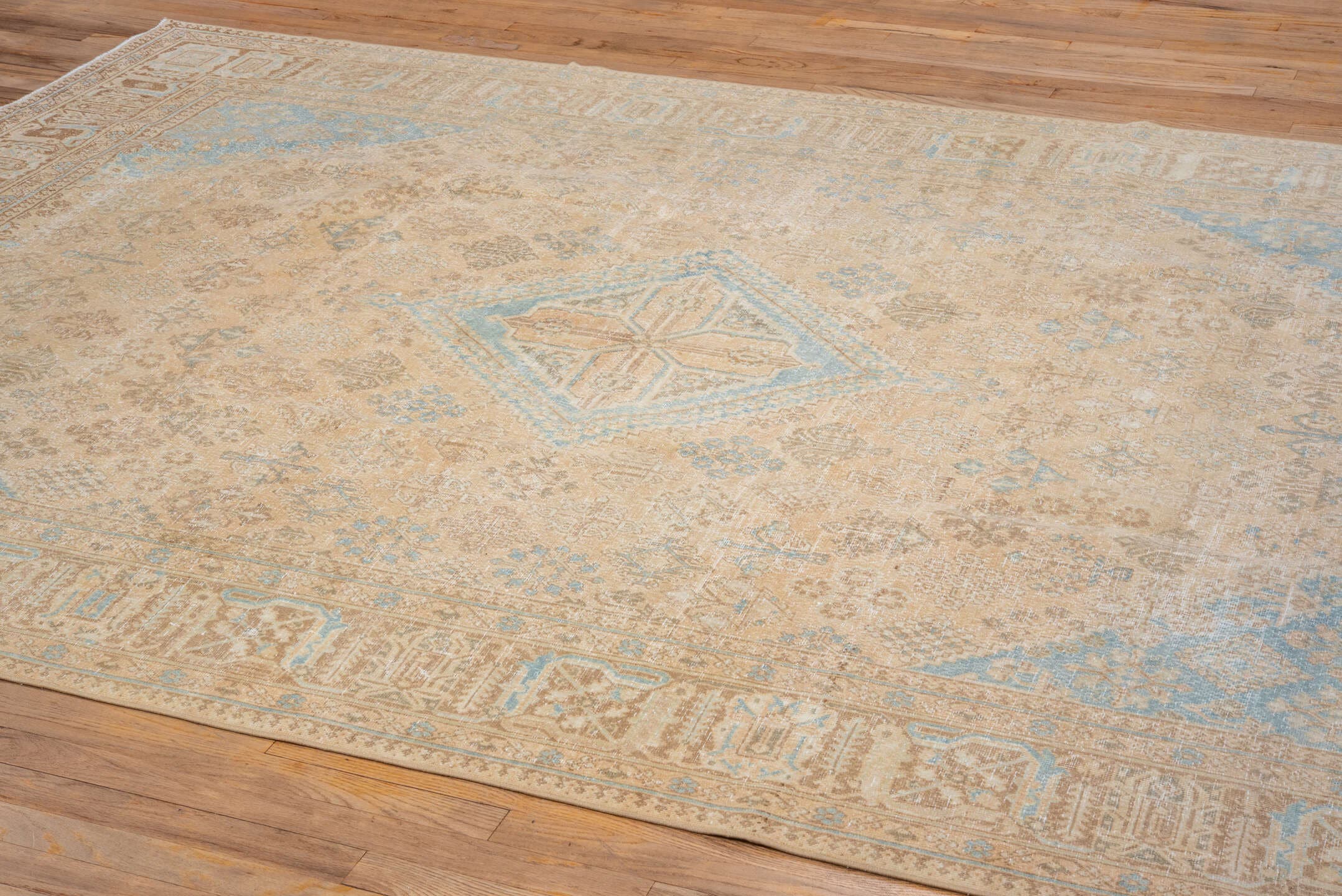 7' x 10' one-of-a-kind handmade vintage Joshegan large size rug. Color palette: camel, ivory, sky_blue, taupe, tan