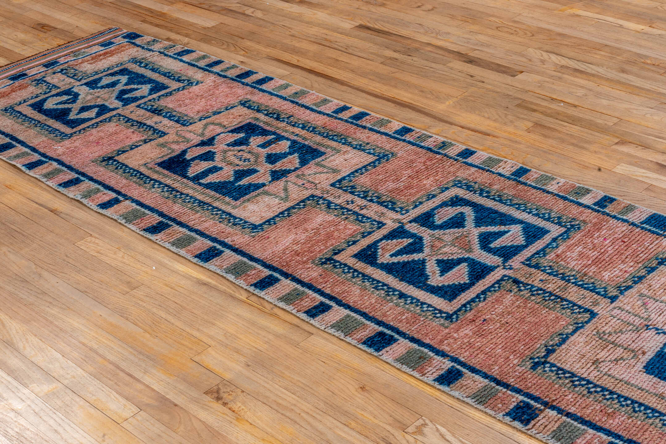 2' x 11' one-of-a-kind handmade vintage Kars runner rug. Color palette: rose, indigo, ivory, taupe, camel, brown, pink, red