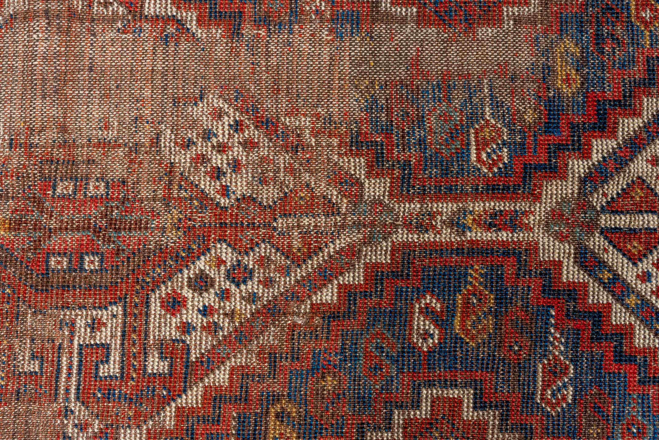 7' x 9' one-of-a-kind handmade vintage Shiraz rug. Color palette: rust, indigo, camel, ivory, crimson, navy, gold, brown